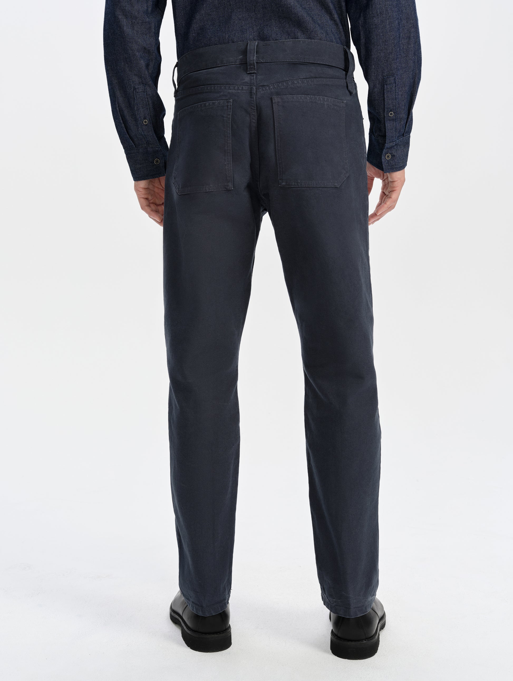 Rear lower-body view of man wearing the Porter 5-Pocket Pant in Graphite from AETHER Apparel.