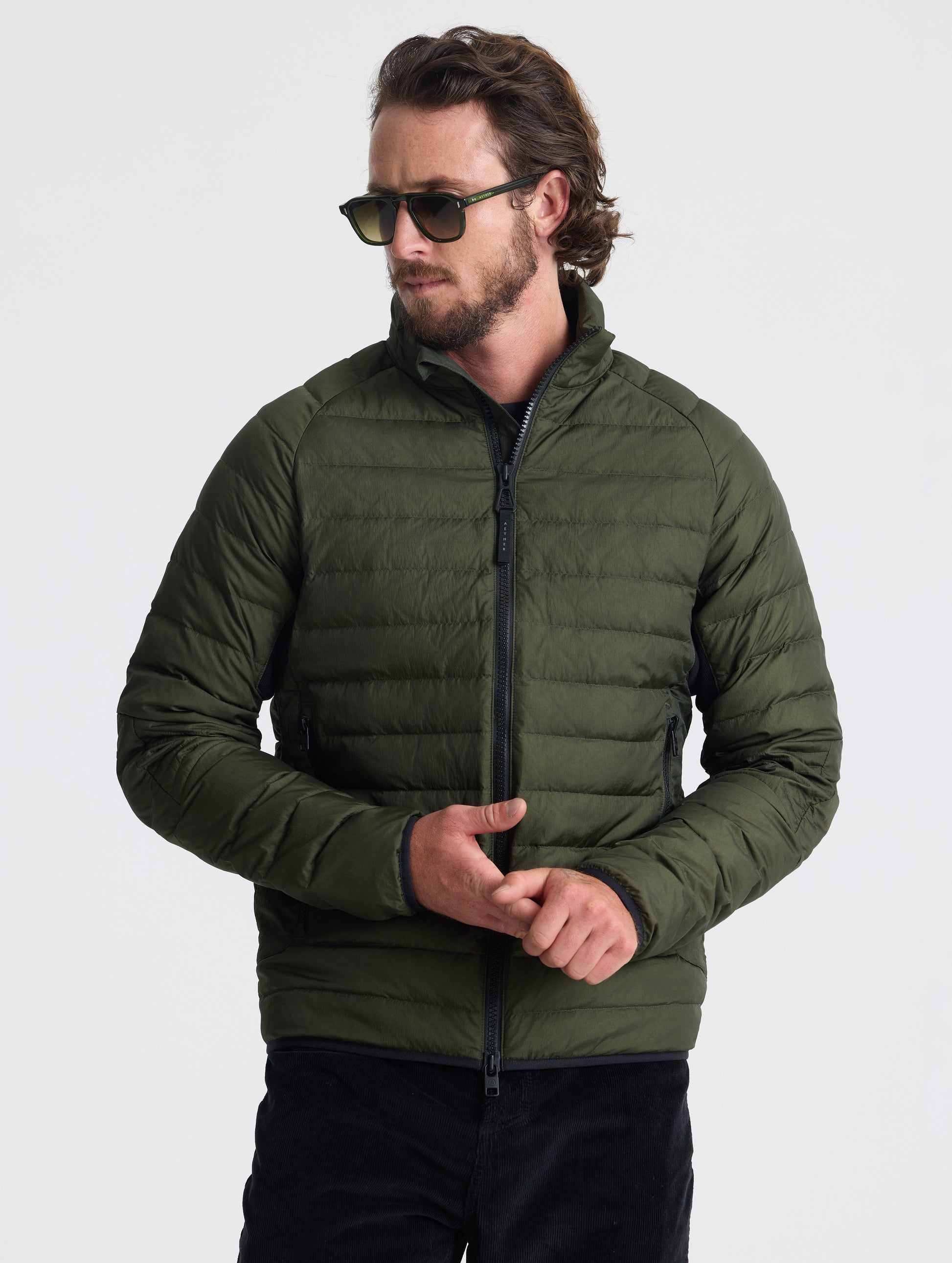 Front view of man wearing Prospect Packable Down Jacket in Forest Green from AETHER Apparel.