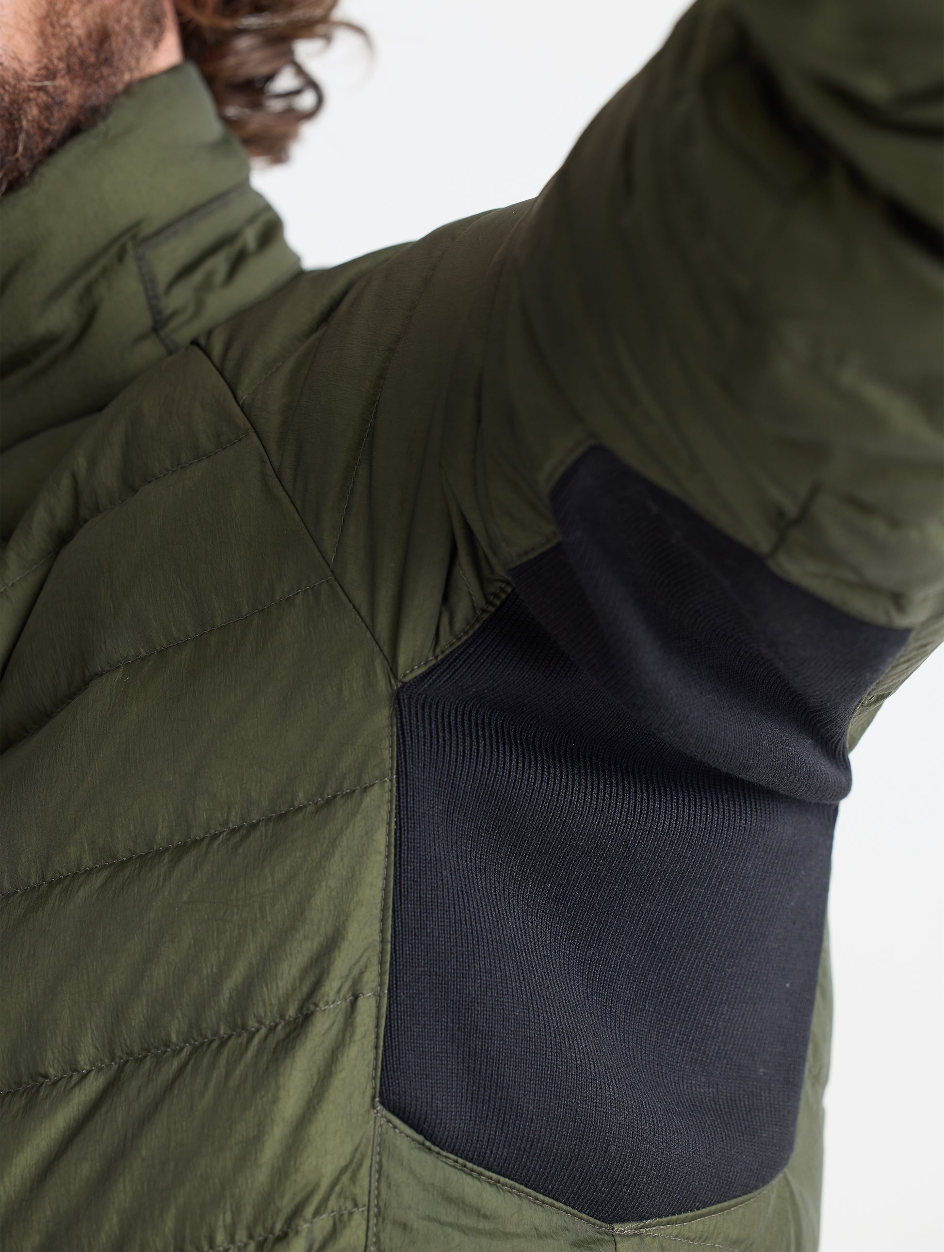 Closeup view of underarm contrast material of Prospect Packable Down Jacket in Forest Green from AETHER Apparel.