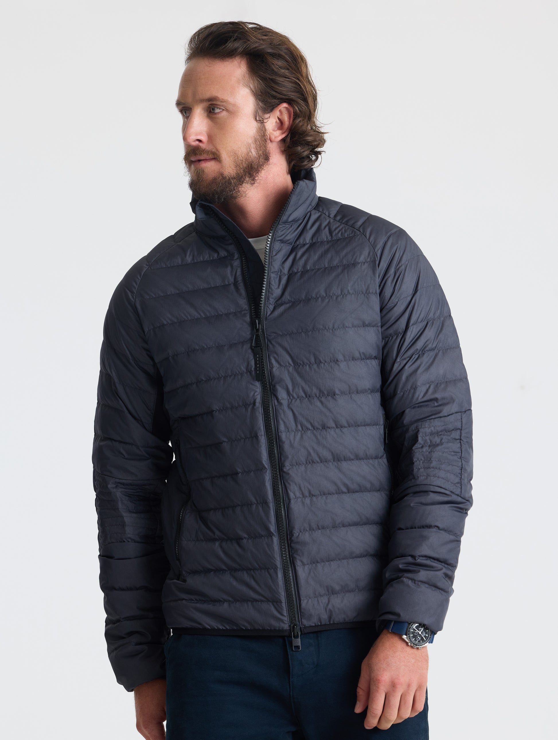 Front view of man wearing Prospect Packable Down Jacket in Onyx Black from AETHER Apparel.