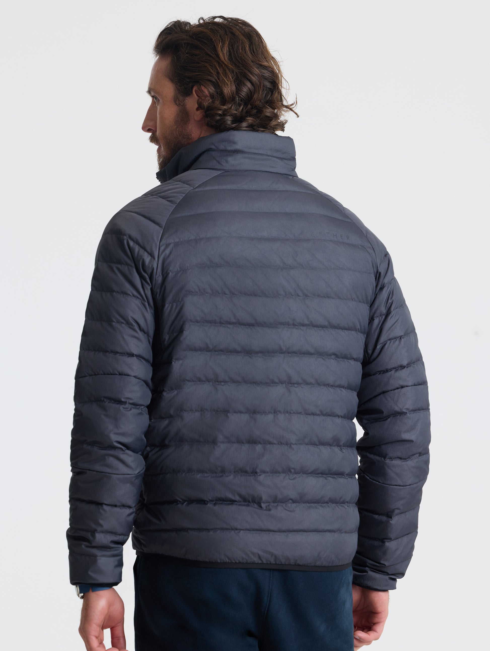 Rear view of man wearing Prospect Packable Down Jacket from AETHER Apparel.
