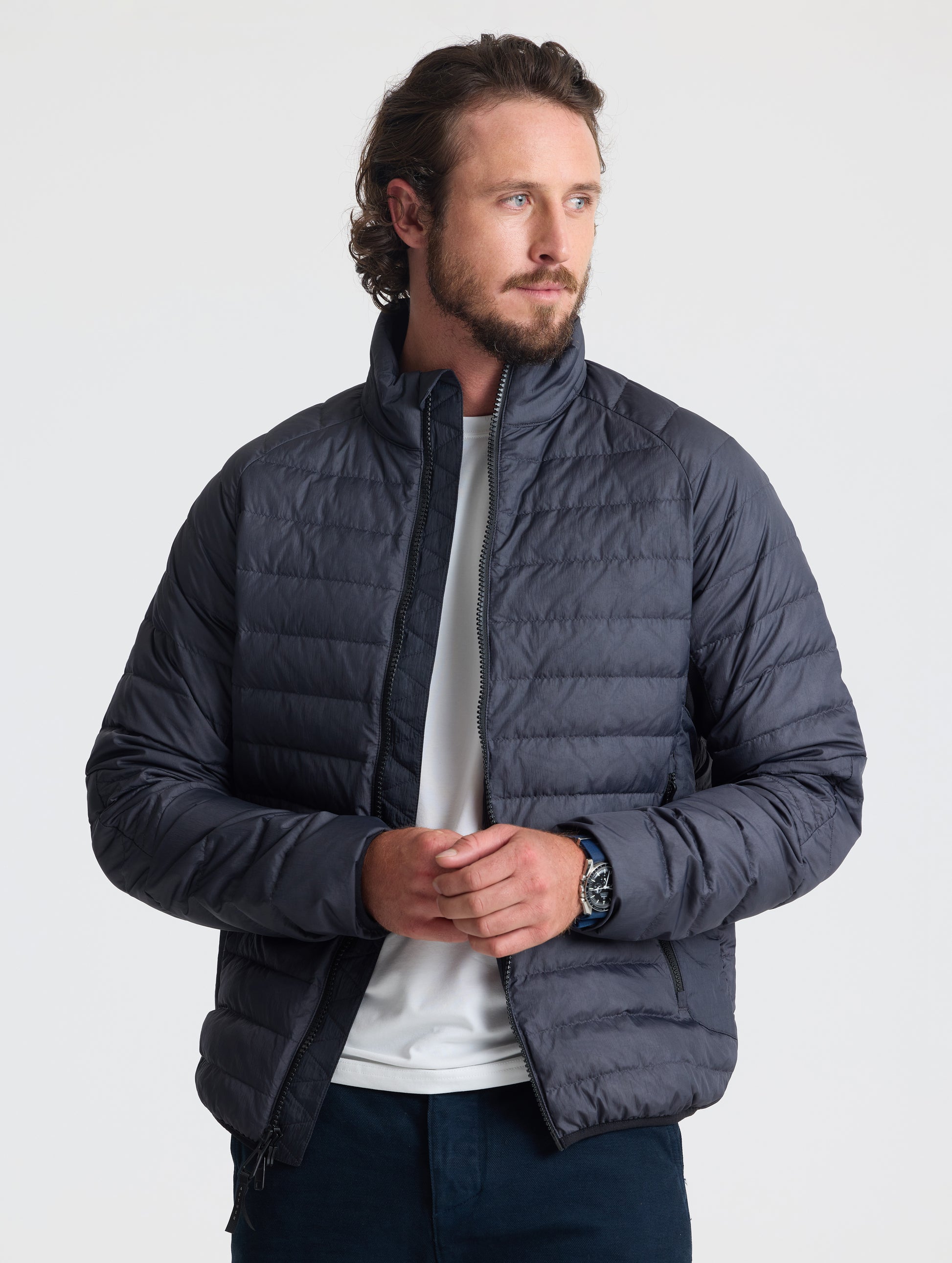 Front view of man wearing unzipped Prospect Packable Down Jacket from AETHER Apparel.