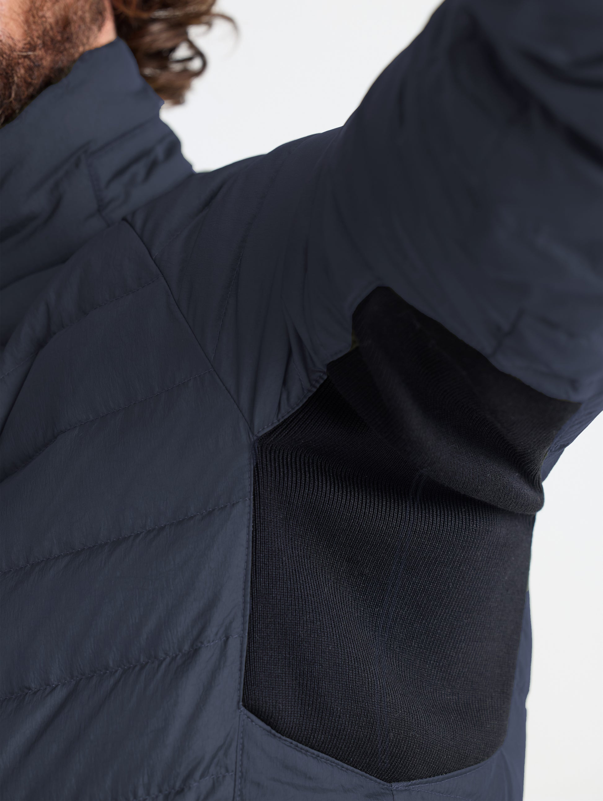 Closeup view of underarm contrast material of Prospect Packable Down Jacket in Onyx Black from AETHER Apparel.