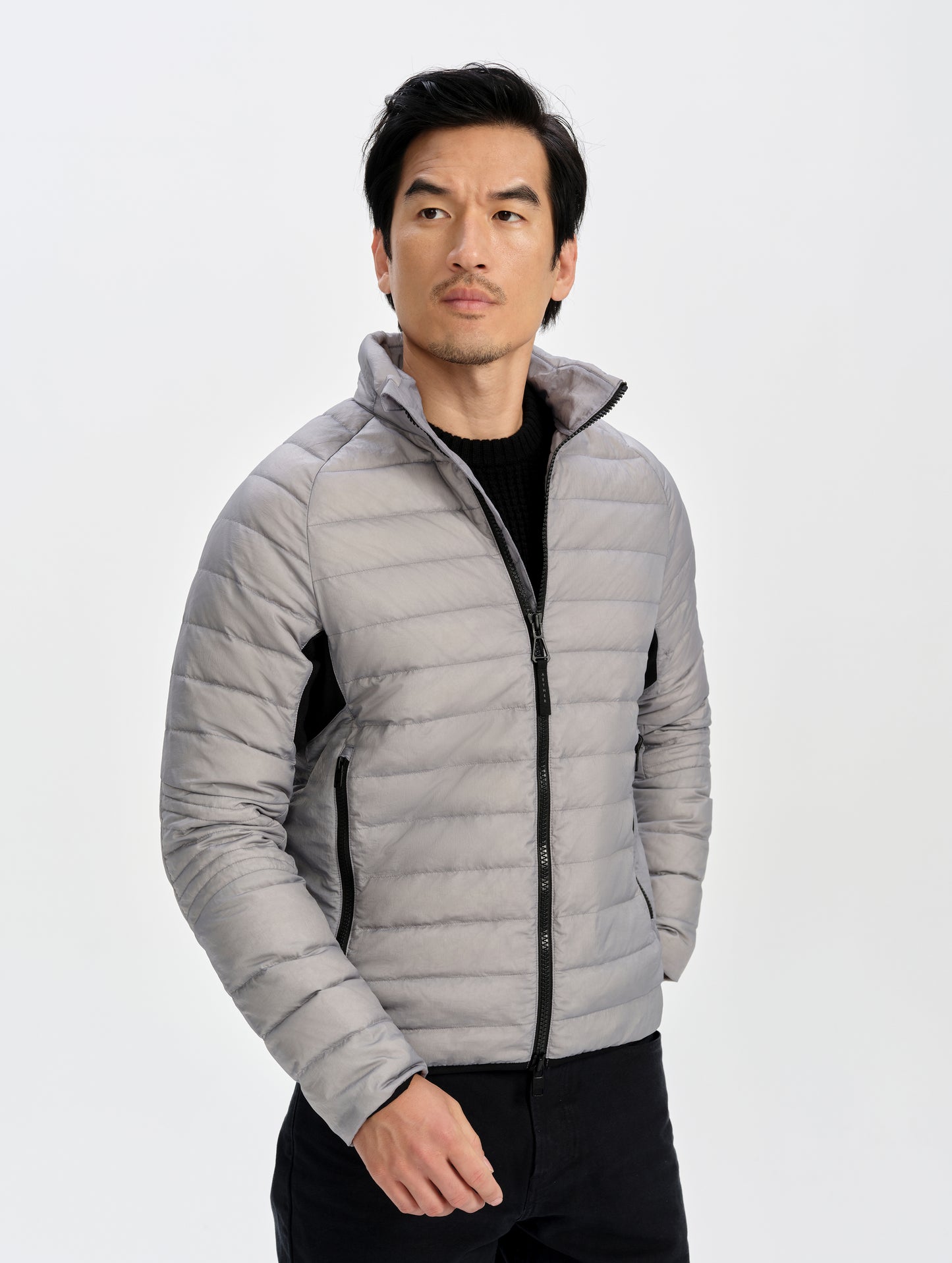 Front upper-body view of man wearing Prospect Packable Down Jacket in Sky Grey from AETHER Apparel.