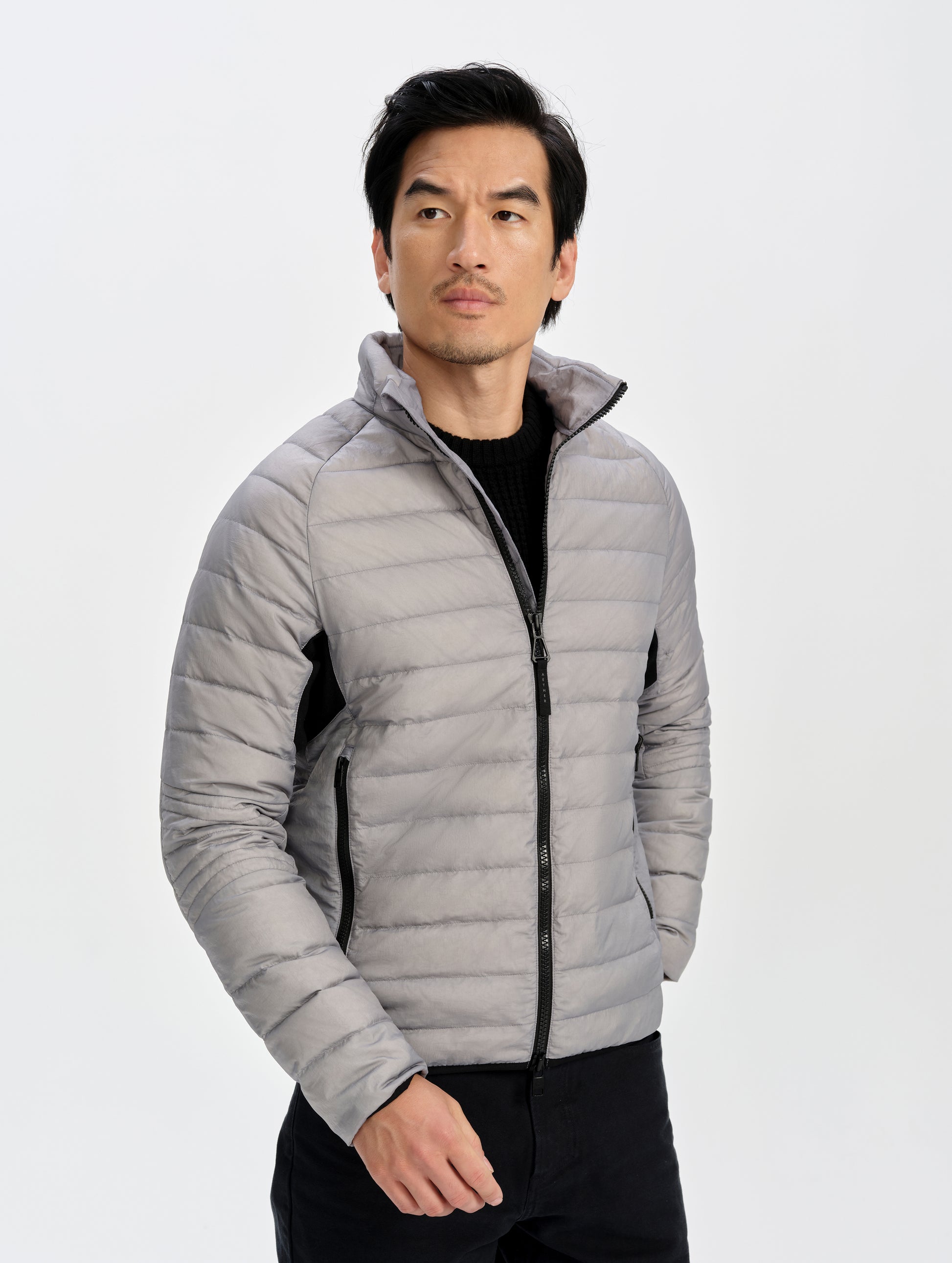 Front upper-body view of man wearing Prospect Packable Down Jacket in Sky Grey from AETHER Apparel.