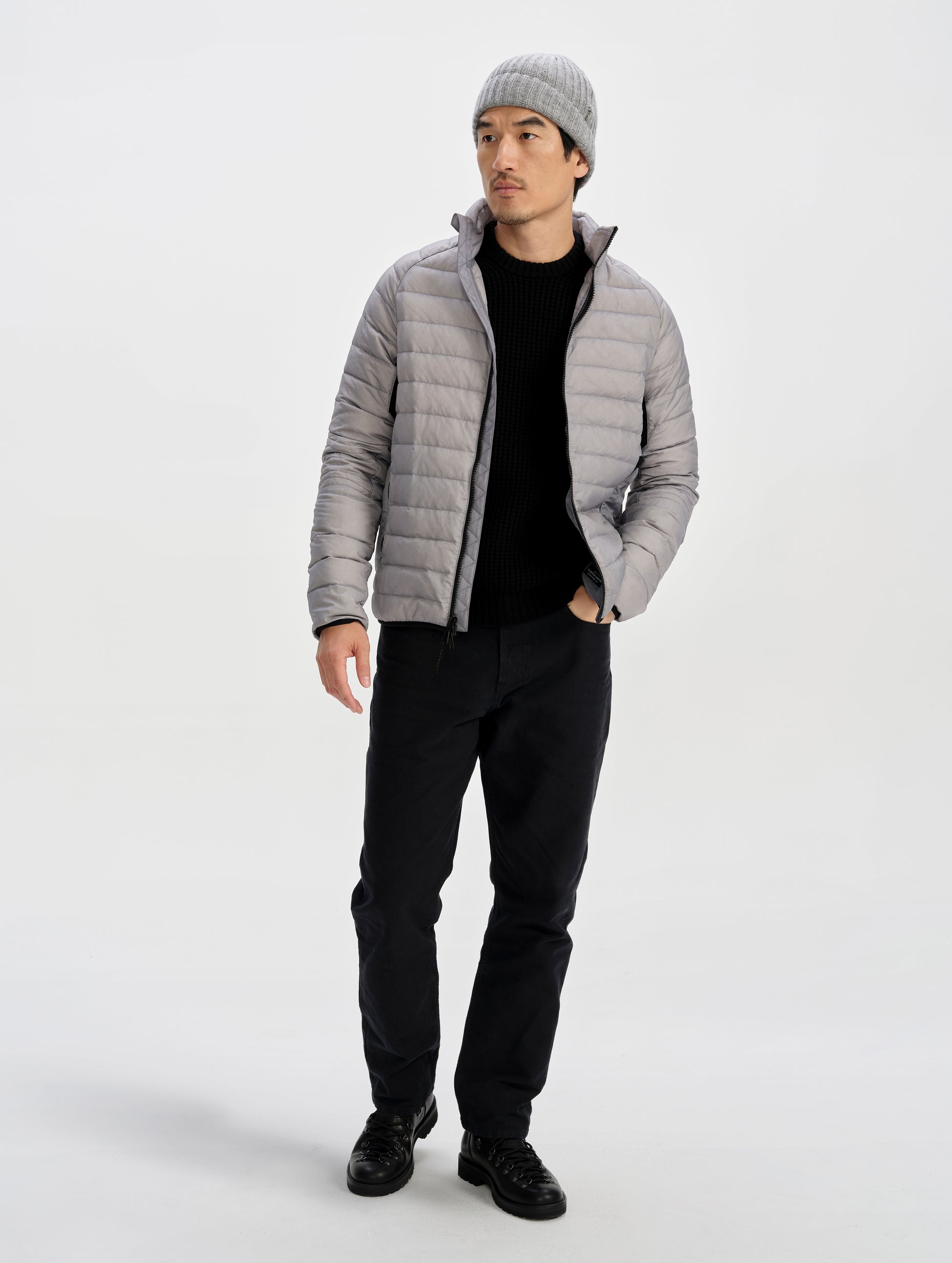 Front full-body view of man wearing Prospect Packable Down Jacket in Sky Grey from AETHER Apparel.