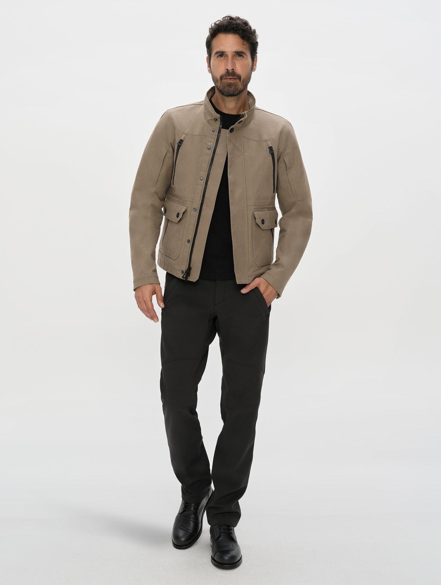 Front, full-body view of man wearing the Ramble Motorcycle Pant 3.0 in Onyx Black from AETHER Apparel.