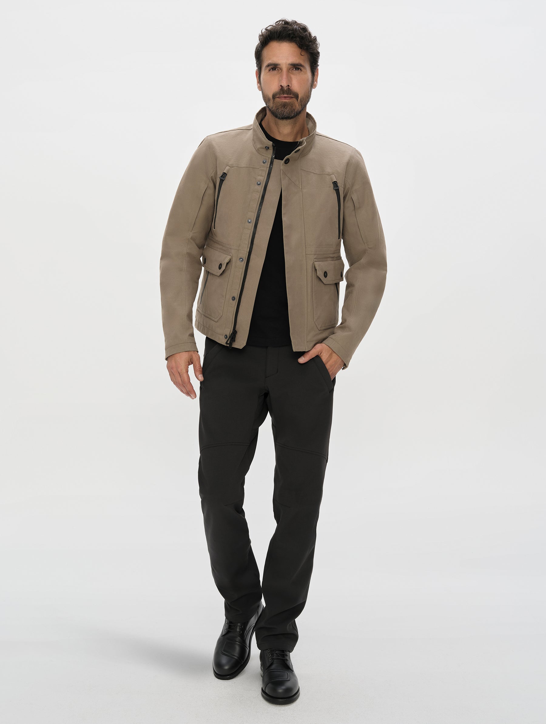 Front, full-body view of man wearing the Ramble Motorcycle Pant 3.0 in Onyx Black from AETHER Apparel.