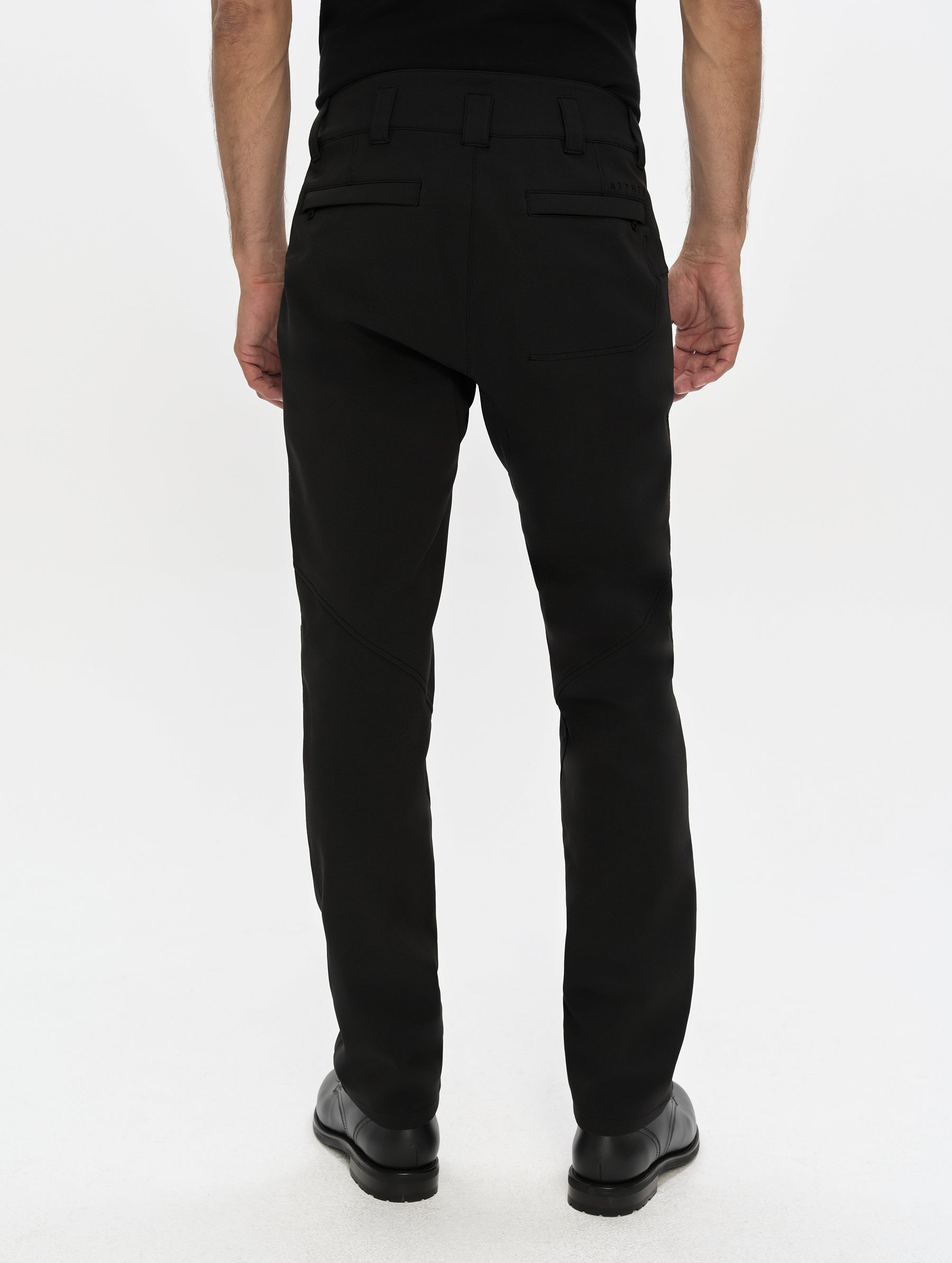 Rear, lower-body view of man wearing the Ramble Motorcycle Pant 3.0 in Onyx Black from AETHER Apparel.