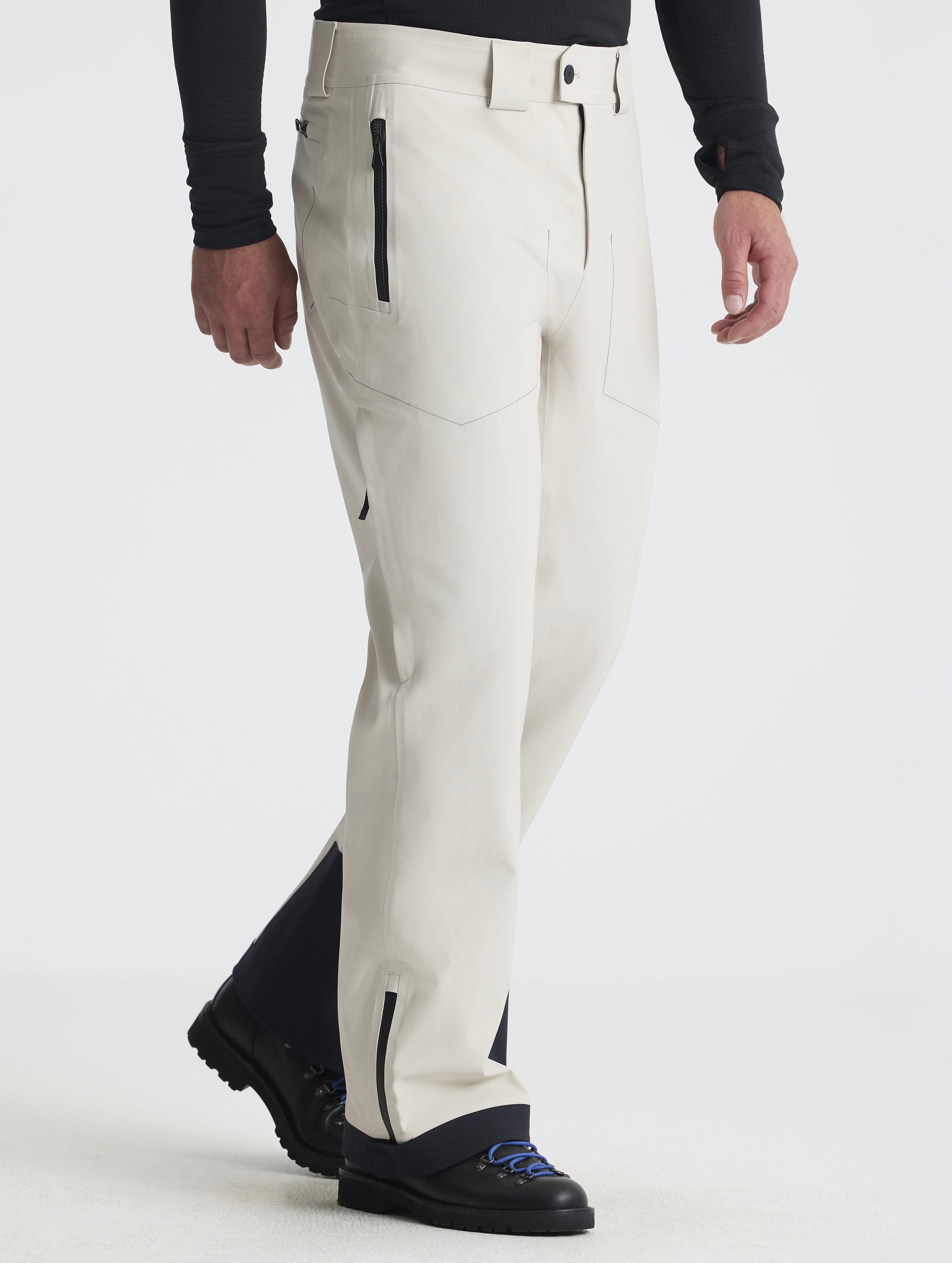Front angled lower-body view of man wearing the Ridge Insulated Snow Pant in Bone from AETHER Apparel.