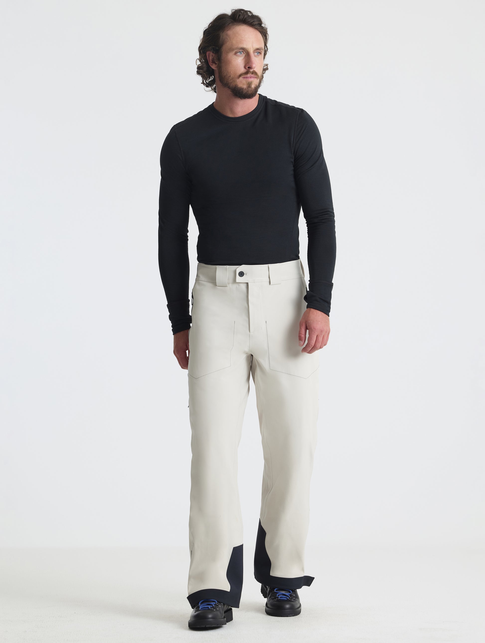 Front full-body view of man wearing the Ridge Insulated Snow Pant in Bone from AETHER Apparel.