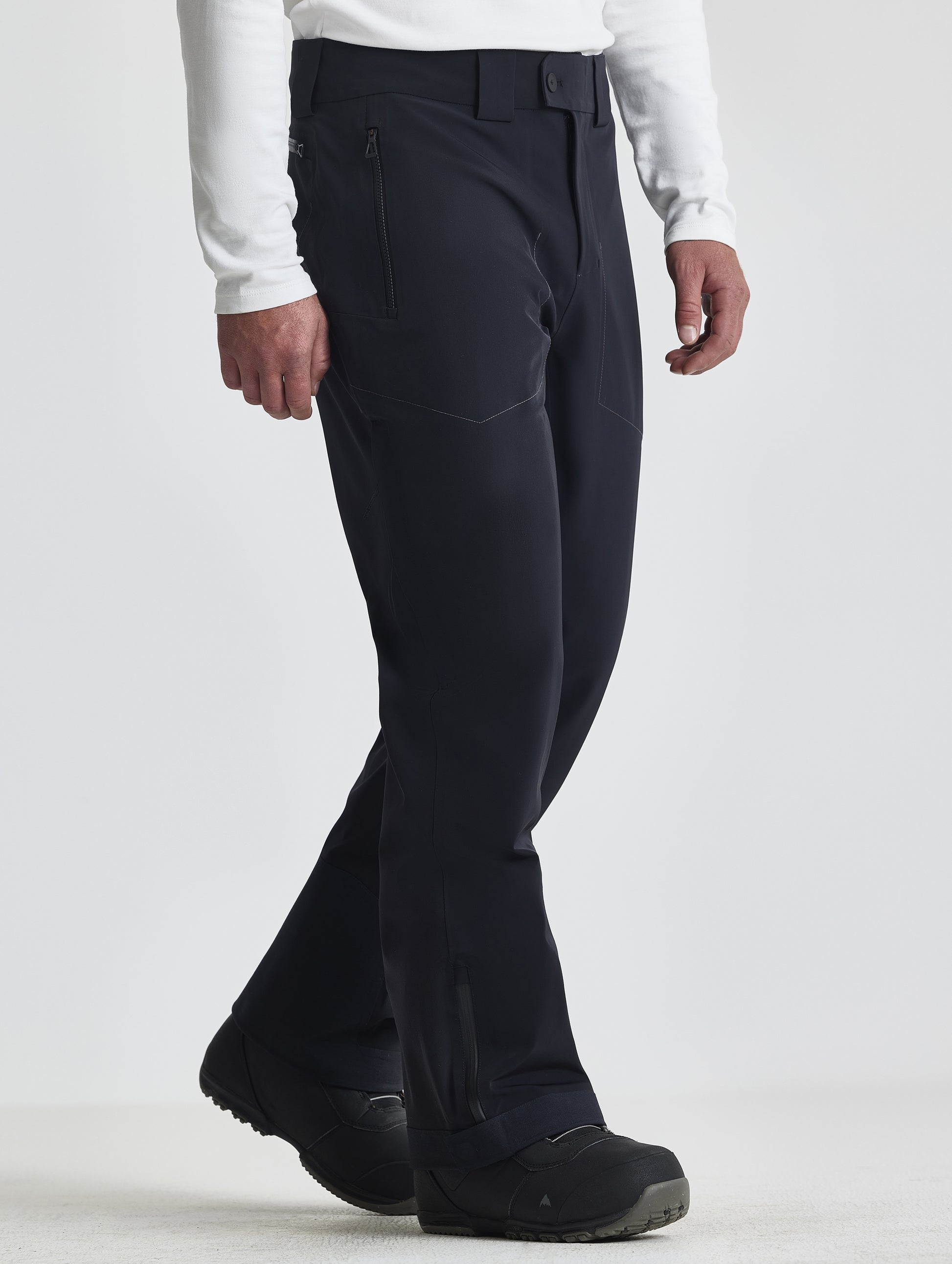 Front angled lower-body view of man wearing the Ridge Insulated Snow Pant in Onyx Black from AETHER Apparel.