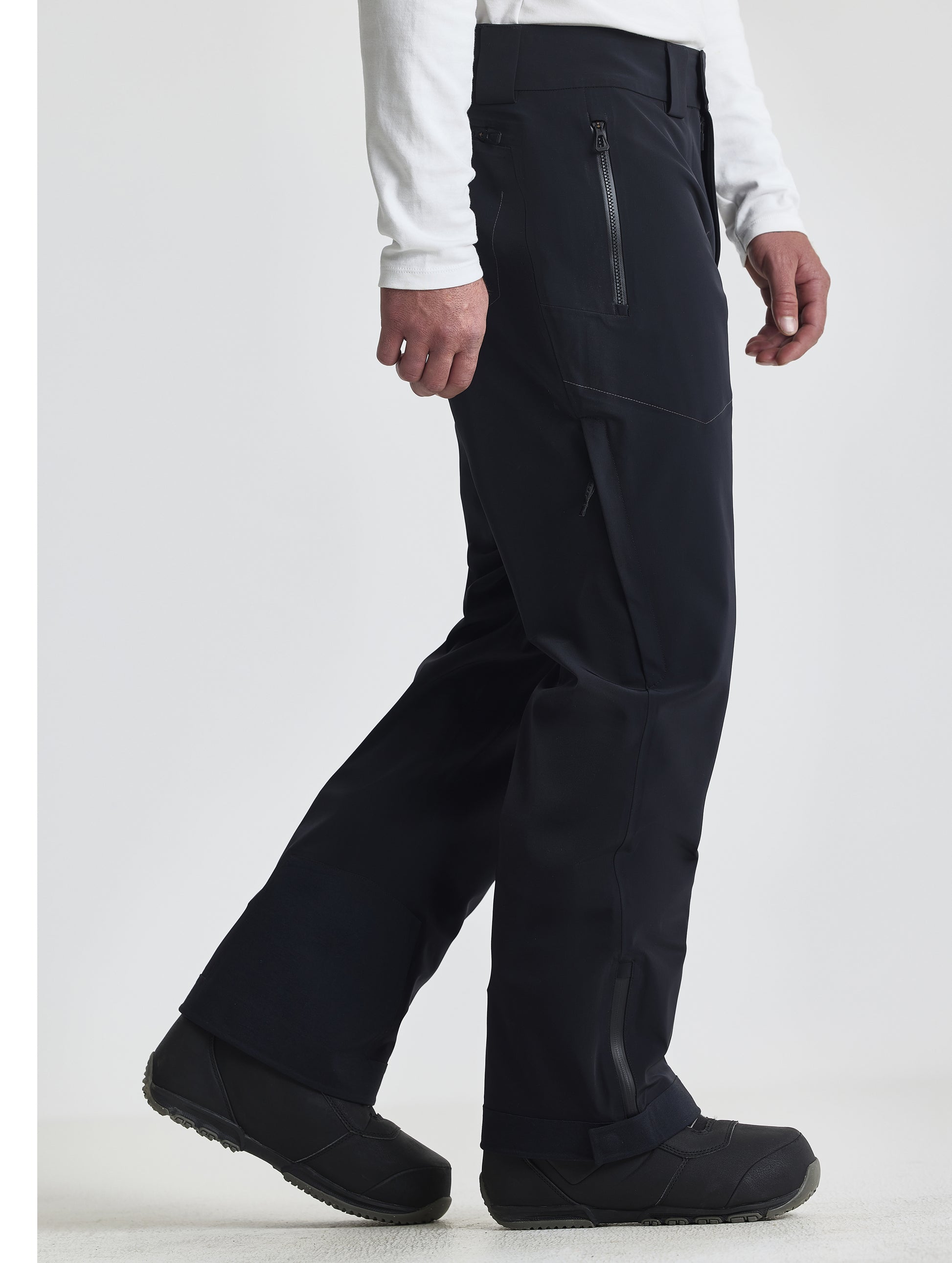 Side profile view of man wearing the Ridge Insulated Snow Pant in Onyx Black from AETHER Apparel.