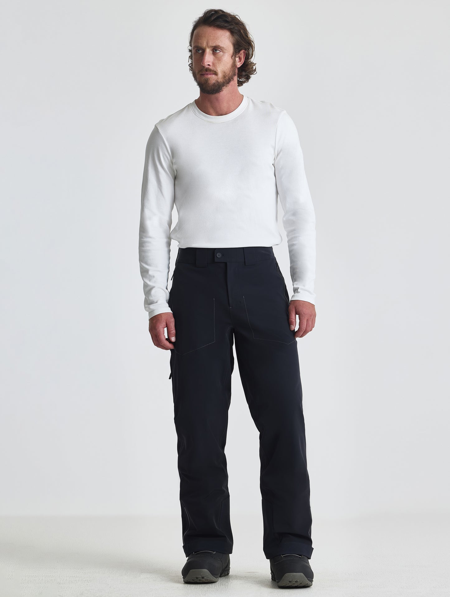 Front full-body view of man wearing the Ridge Insulated Snow Pant in Onyx Black from AETHER Apparel.