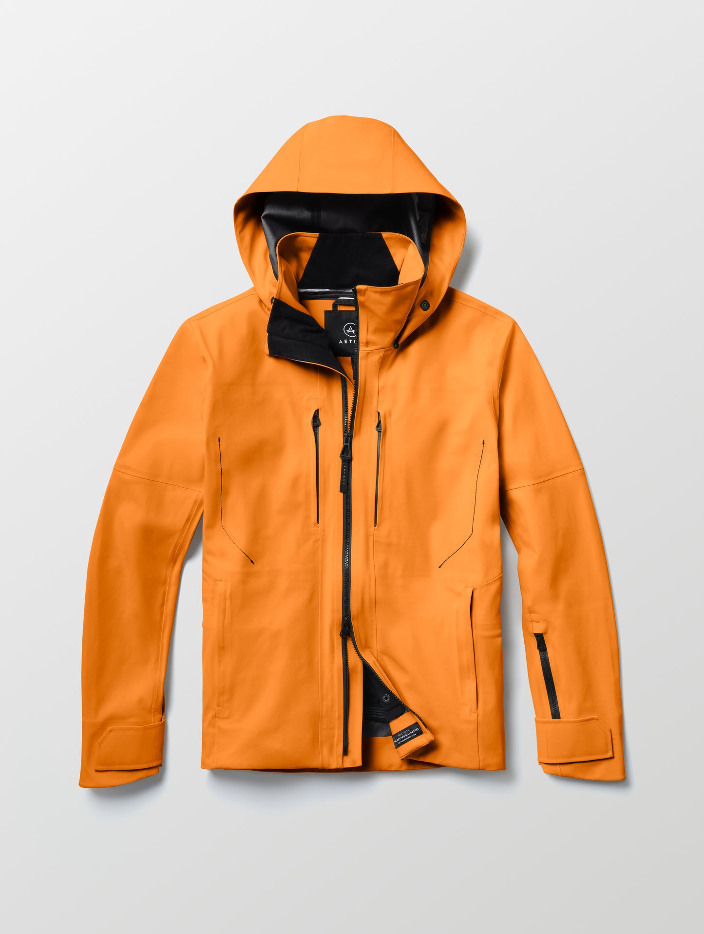 Flat lay of the Ridge Snow-Shell Jacket in Autumn Orange from AETHER Apparel.