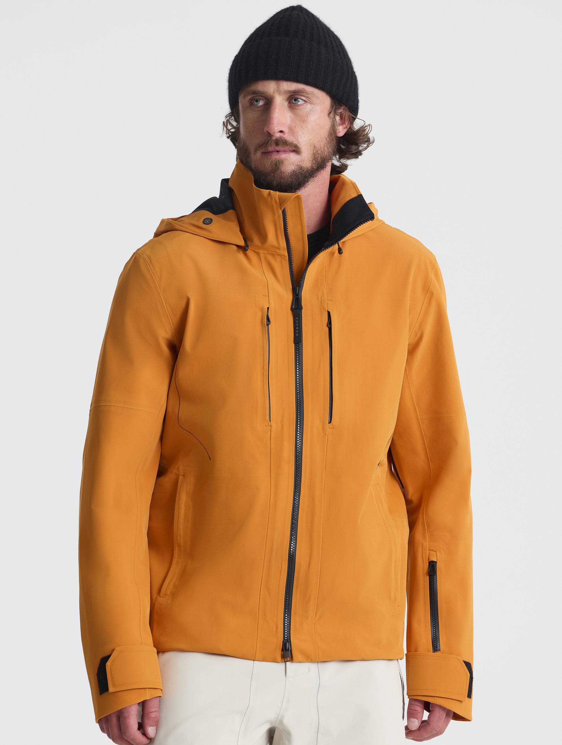 Front upper-body view of man wearing the Ridge Snow-Shell Jacket in Autumn Orange from AETHER Apparel.