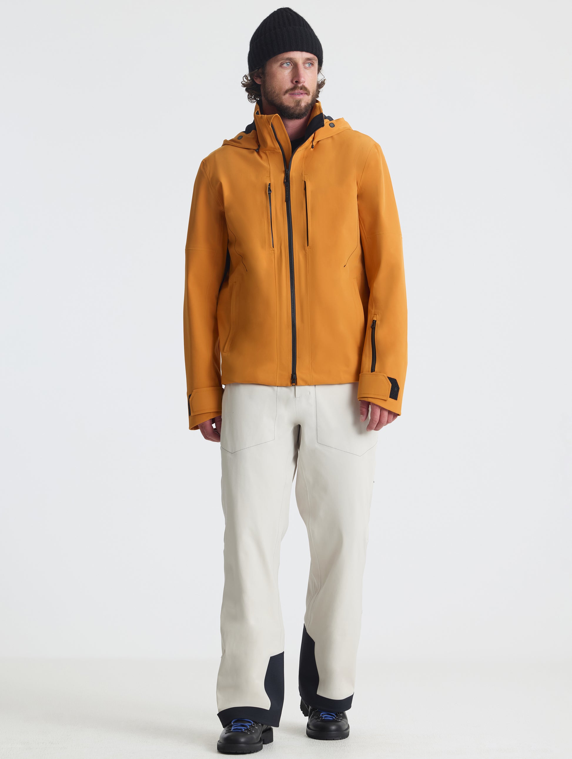 Front full-body view of man wearing the Ridge Snow-Shell Jacket in Autumn Orange from AETHER Apparel.