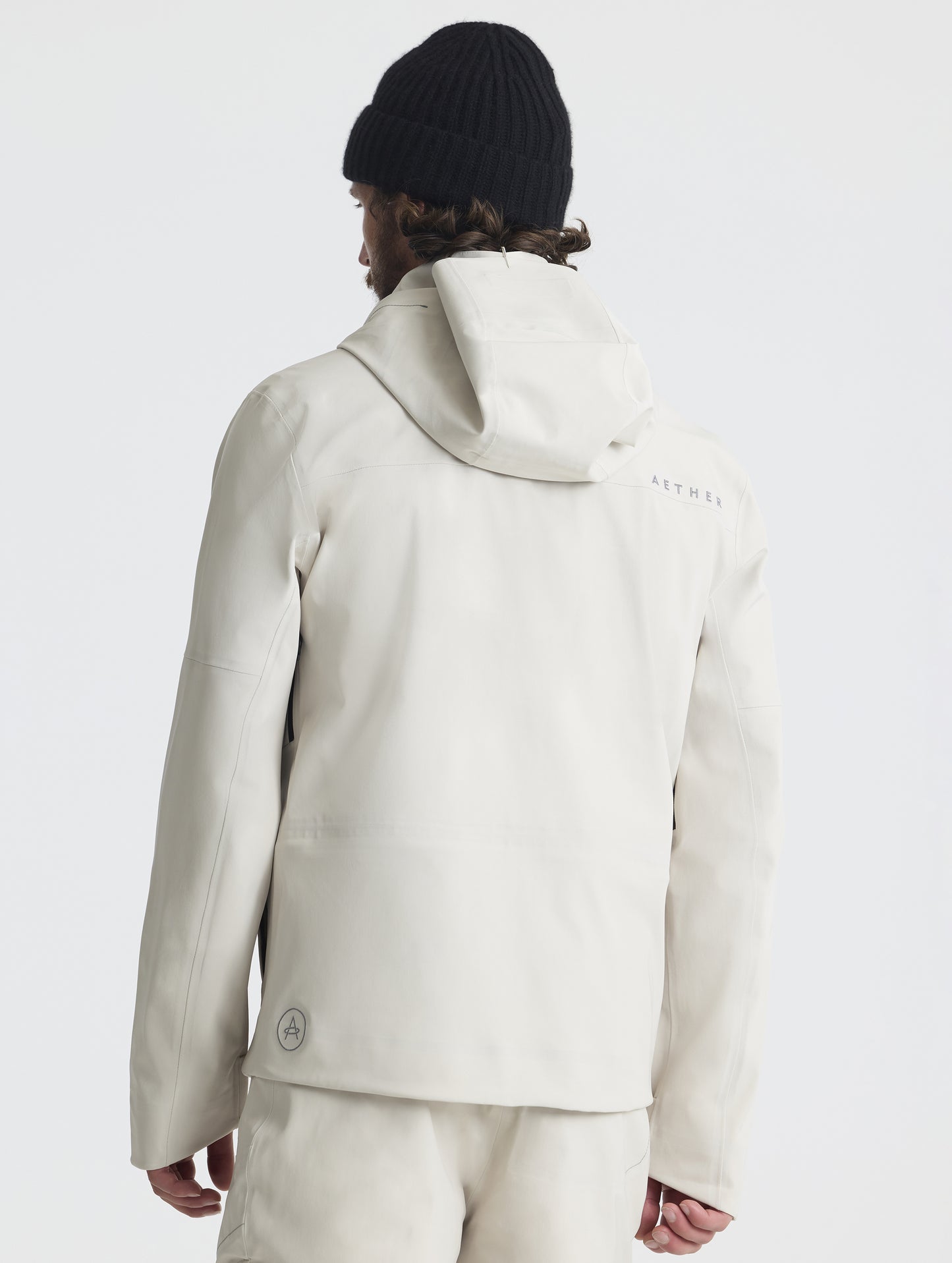 Rear upper-body view of man wearing the Ridge Snow-Shell Jacket in Bone from AETHER Apparel.