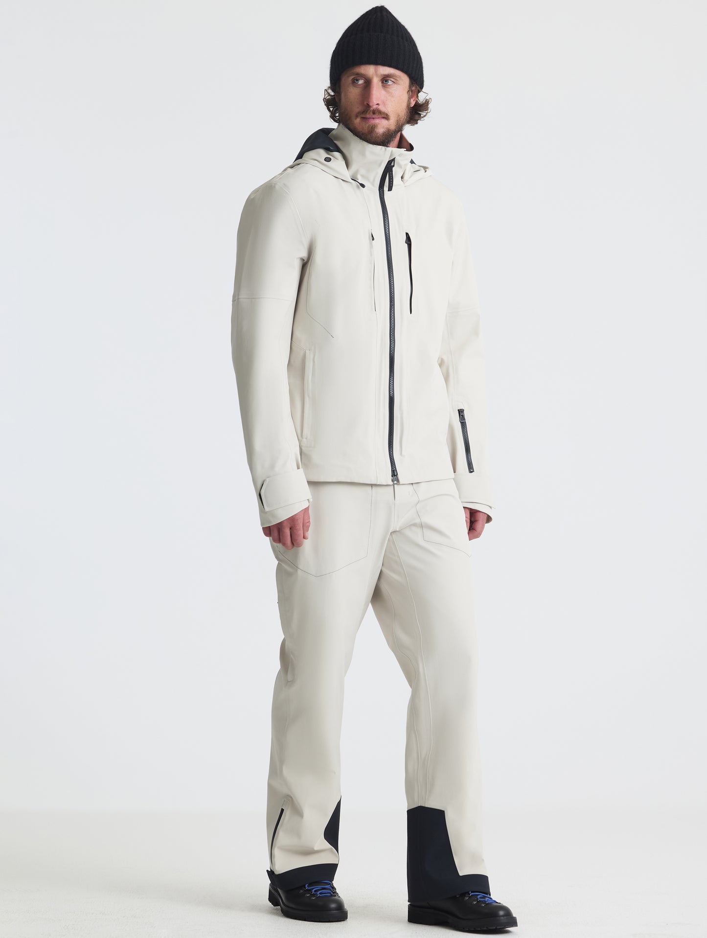 Front angled full-body view of man wearing the Ridge Snow-Shell Jacket in Bone from AETHER Apparel.