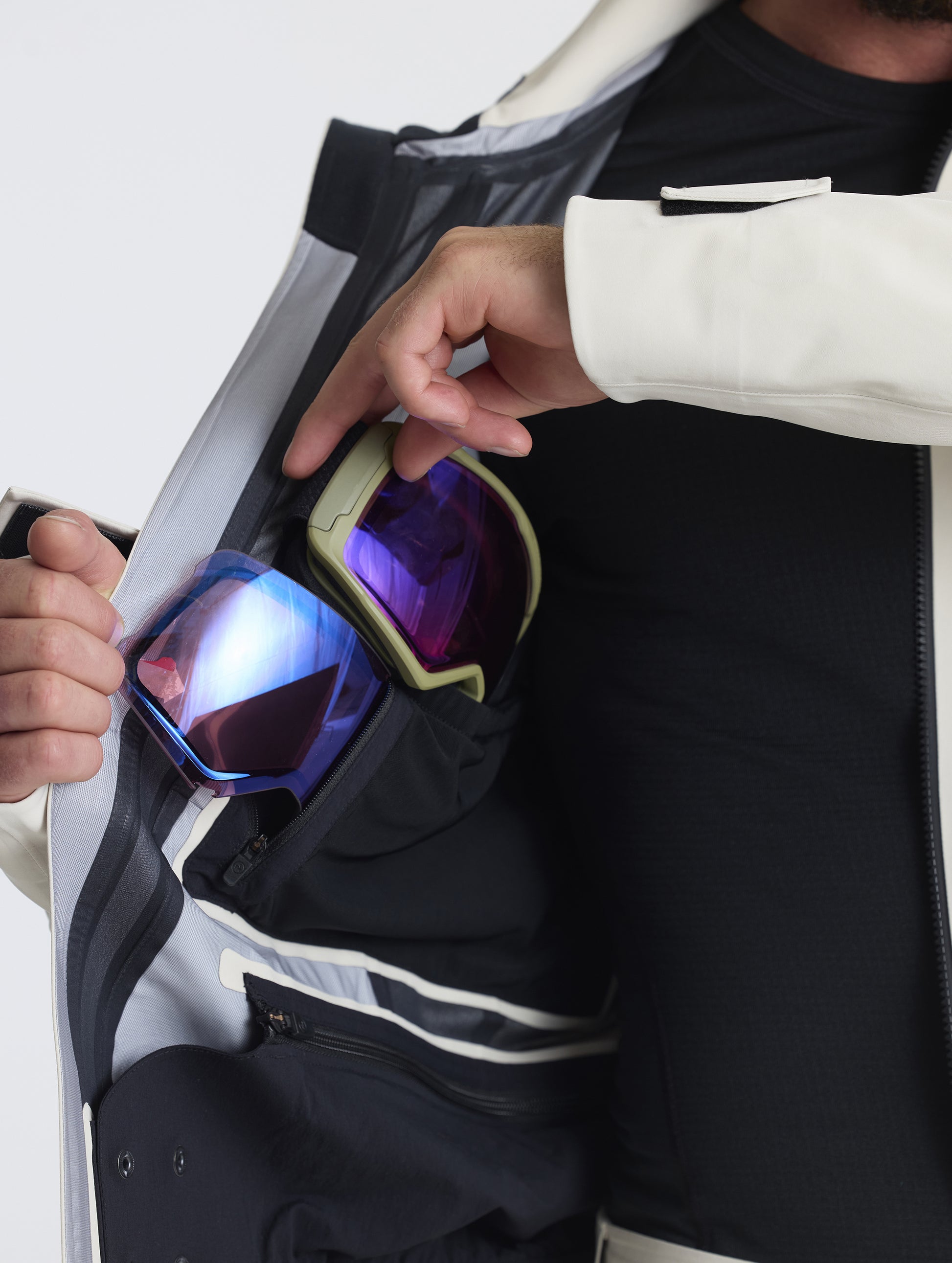 Closeup detailed view of the dedicated goggle pocket on the Ridge Snow-Shell Jacket in Bone from AETHER Apparel.