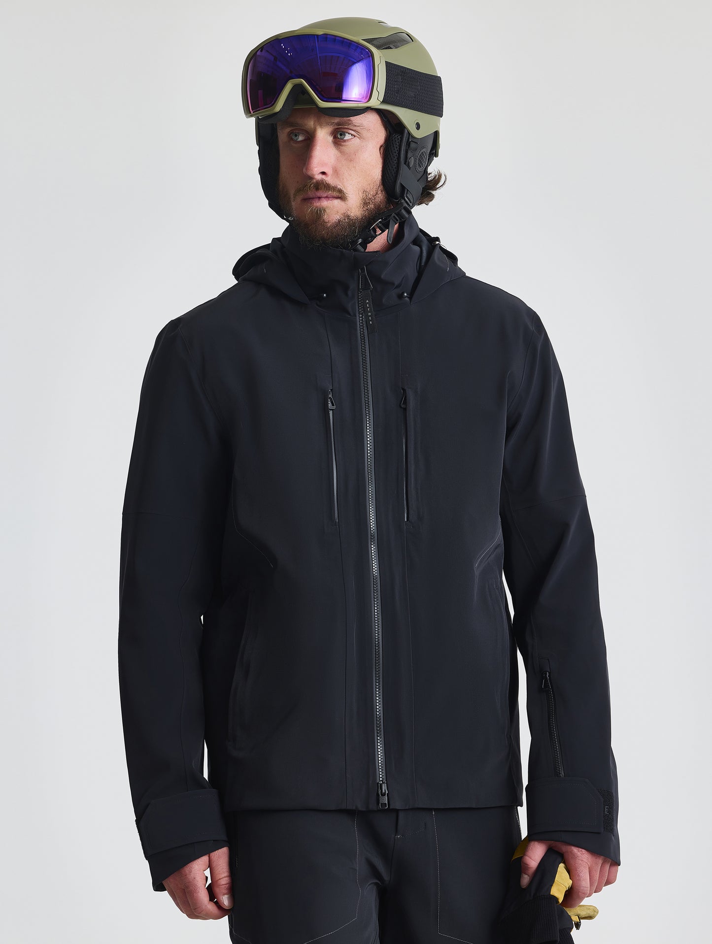 Front upper-body view of man wearing the Ridge Snow-Shell Jacket in Onyx Black from AETHER Apparel.