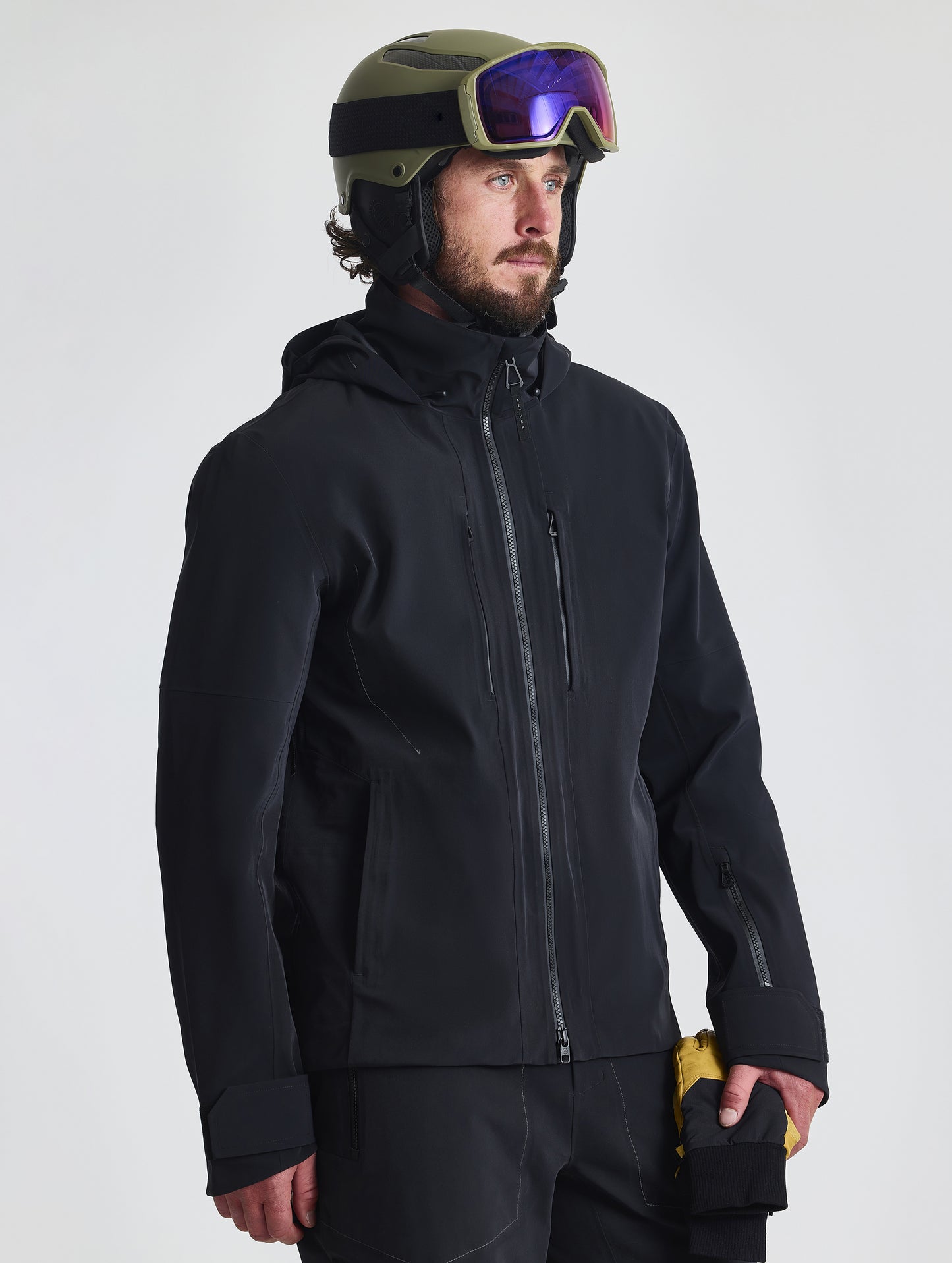 Front angled upper-body view of man wearing the Ridge Snow-Shell Jacket in Onyx Black from AETHER Apparel.