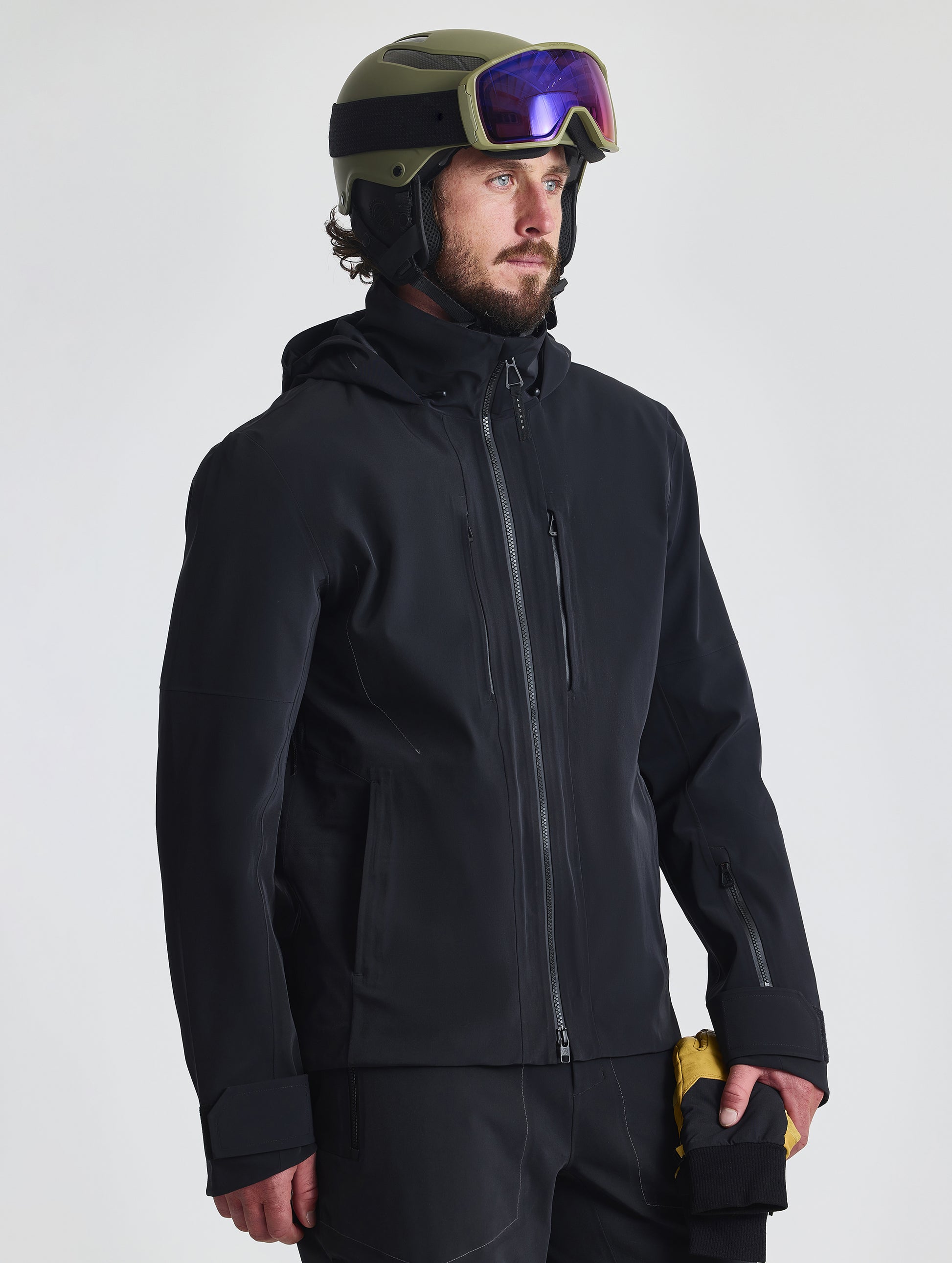 Front angled upper-body view of man wearing the Ridge Snow-Shell Jacket in Onyx Black from AETHER Apparel.
