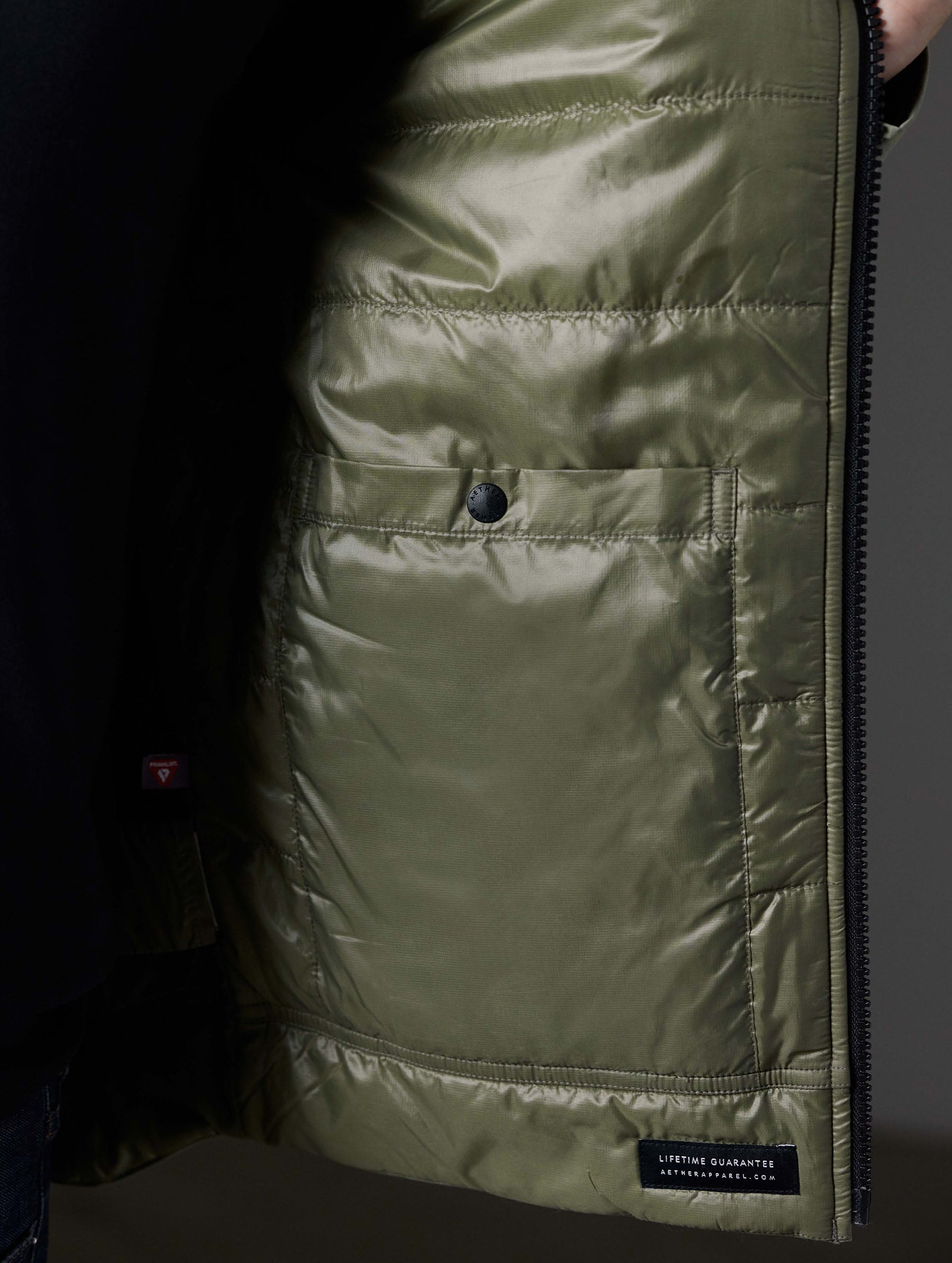 Closeup detailed view of the quilted, recycled interior lining on the Stornaway Insulated Hoodie in Fern Green from AETHER Apparel.