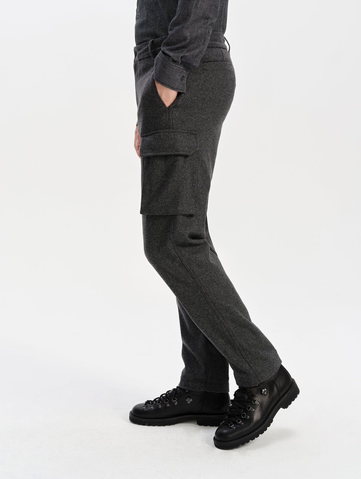 Side profile lower-body view of man wearing the Strata Wool Pant in Charcoal Heather from AETHER Apparel.