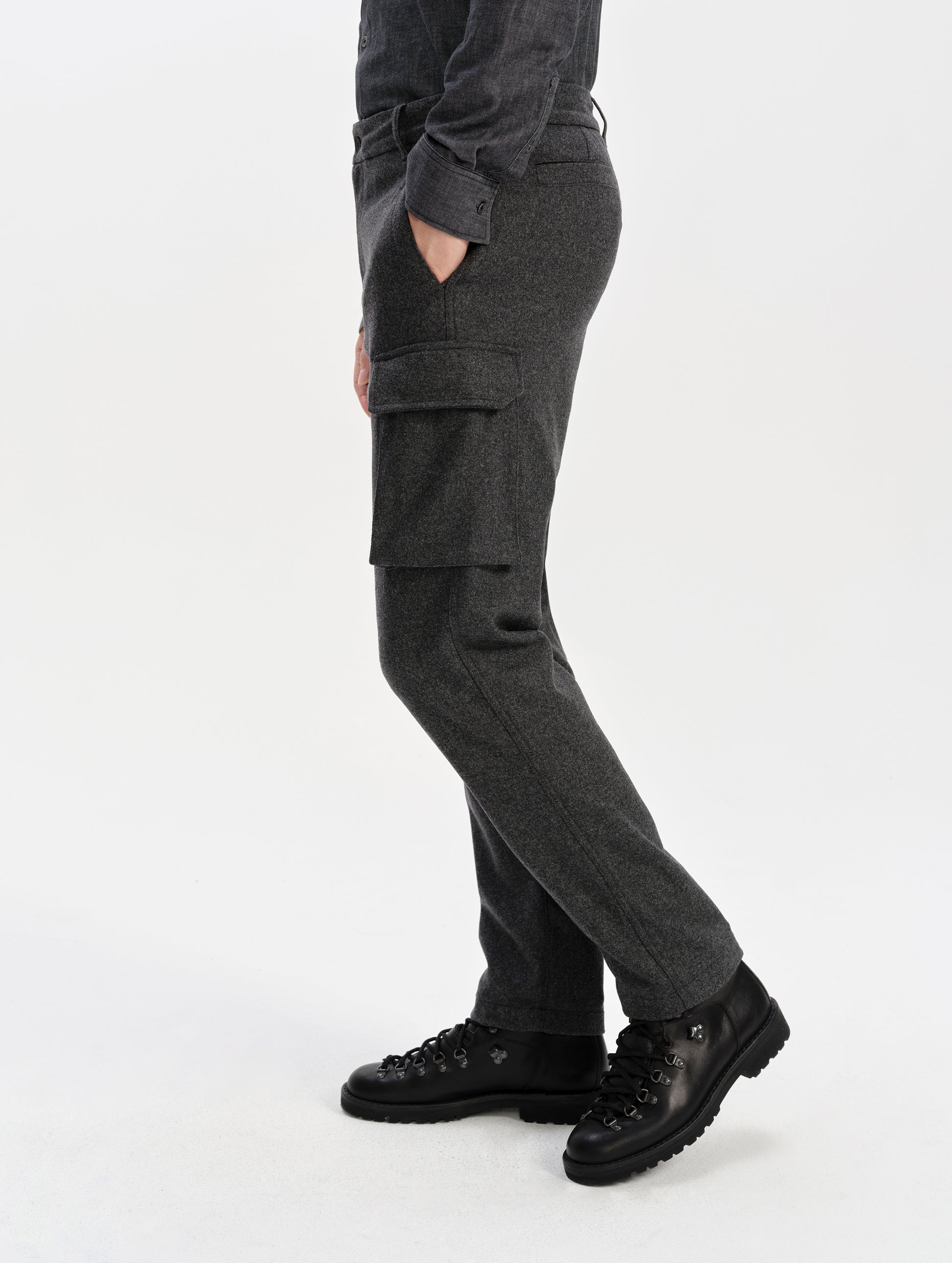 Side profile lower-body view of man wearing the Strata Wool Pant in Charcoal Heather from AETHER Apparel.