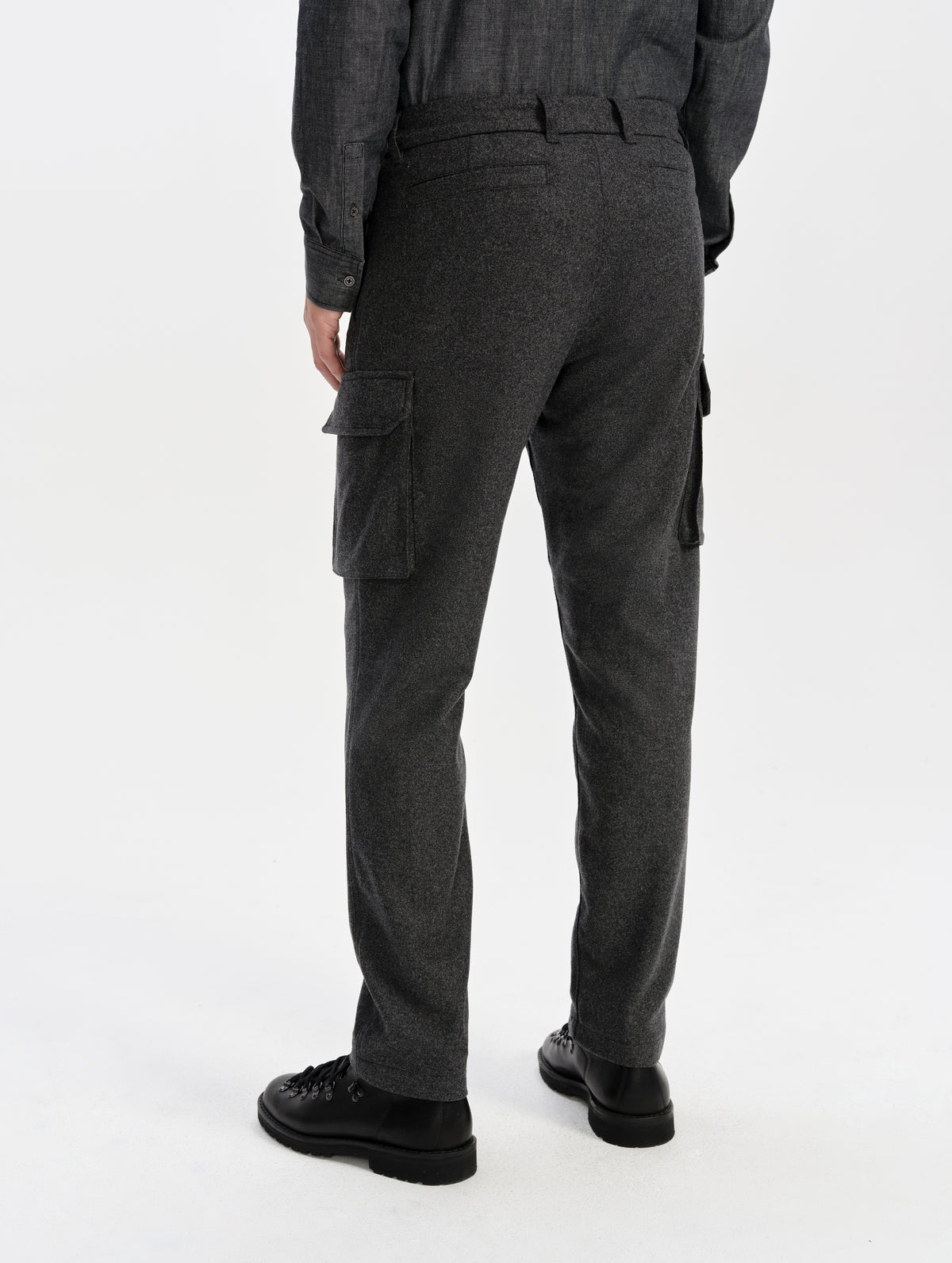 Rear lower-body view of man wearing the Strata Wool Pant in Charcoal Heather from AETHER Apparel.