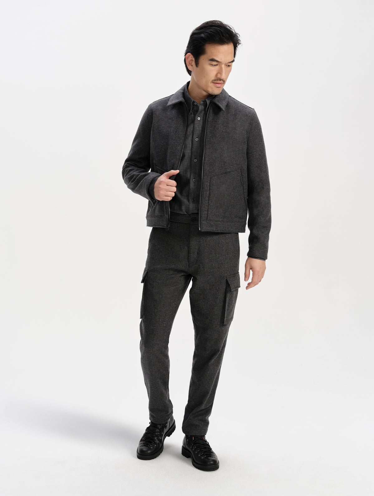 Front full-body view of man wearing the Strata Wool Pant in Charcoal Heather from AETHER Apparel.