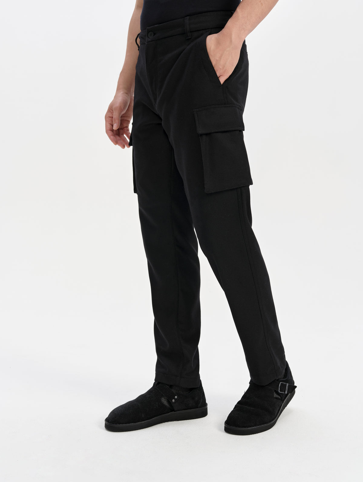 Front 3/4 lower-body view of man wearing the Strata Wool Pant in Onyx Black from AETHER Apparel.