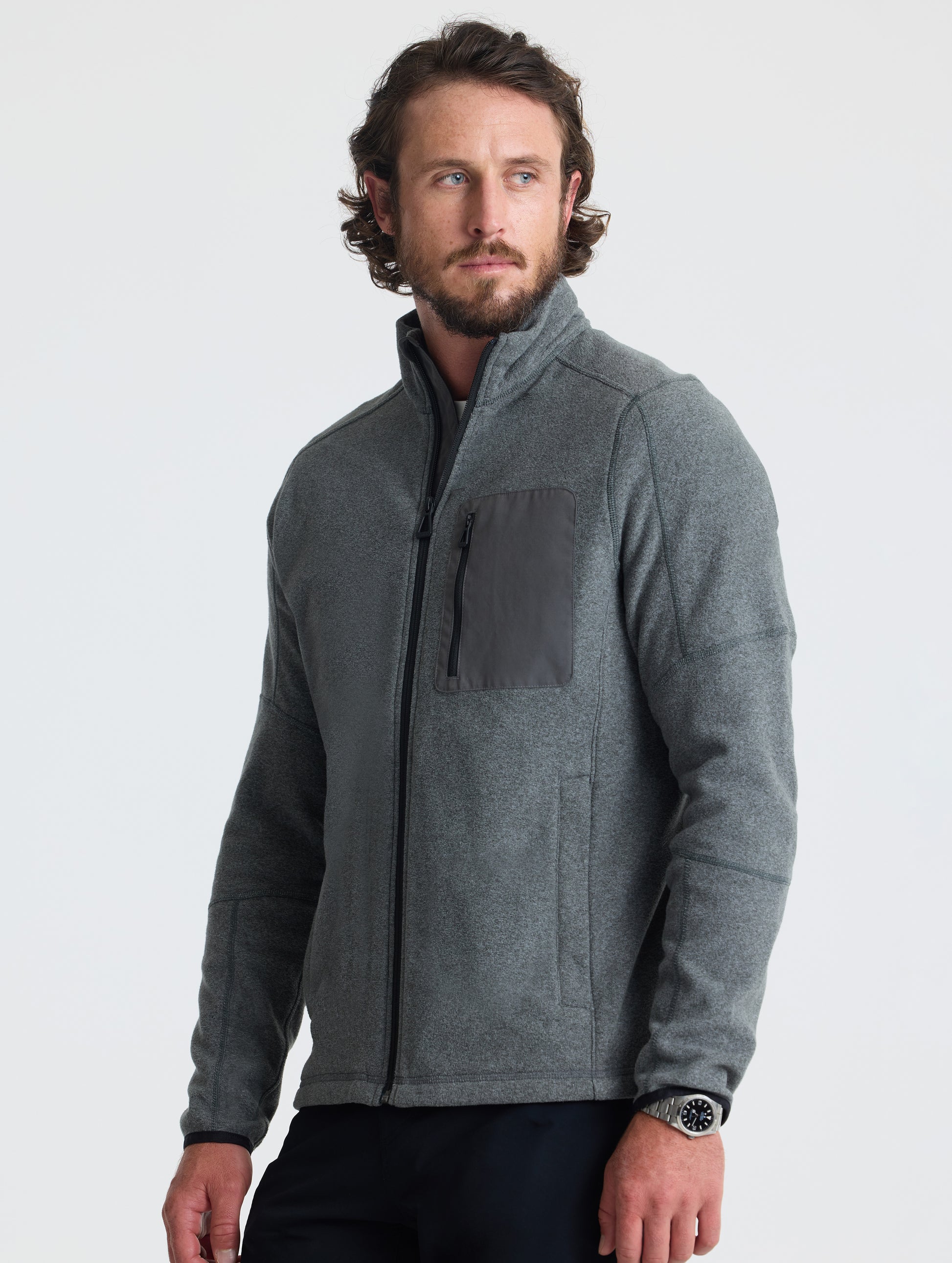 Angled view of man wearing Sutherlin Full-Zip in Charcoal Grey from AETHER Apparel.