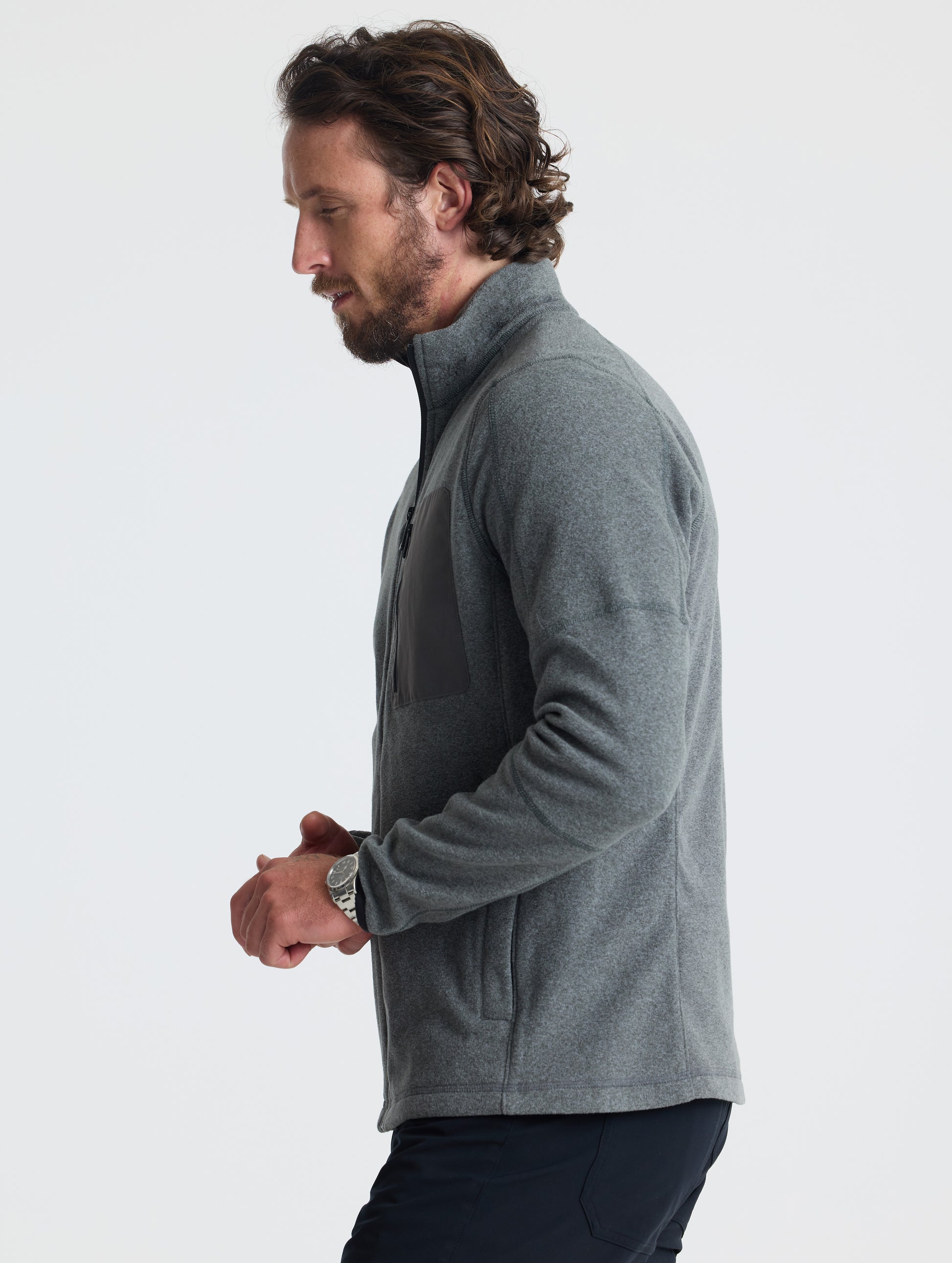 Left profile of man wearing Sutherlin Full-Zip in Charcoal Grey from AETHER Apparel.