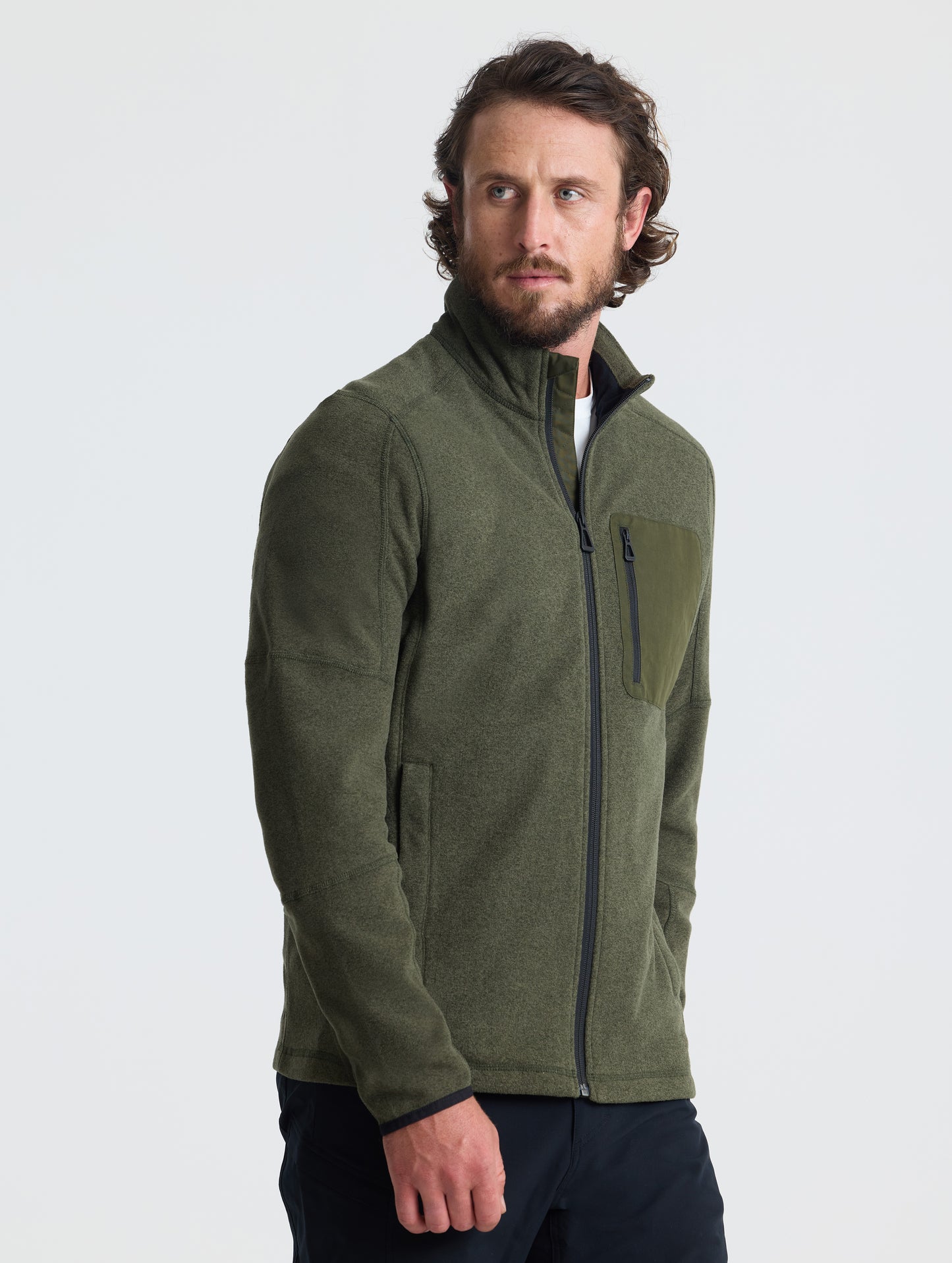 Angled view of man wearing Sutherlin Full-Zip in Forest Green from AETHER Apparel.