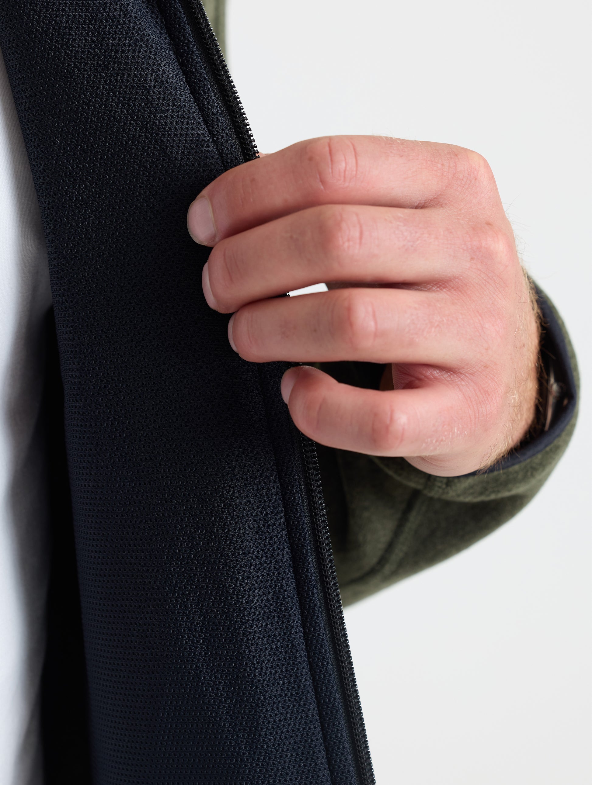 Closeup view of wearer's left interior of Sutherlin Full-Zip in Forest Green from AETHER Apparel.