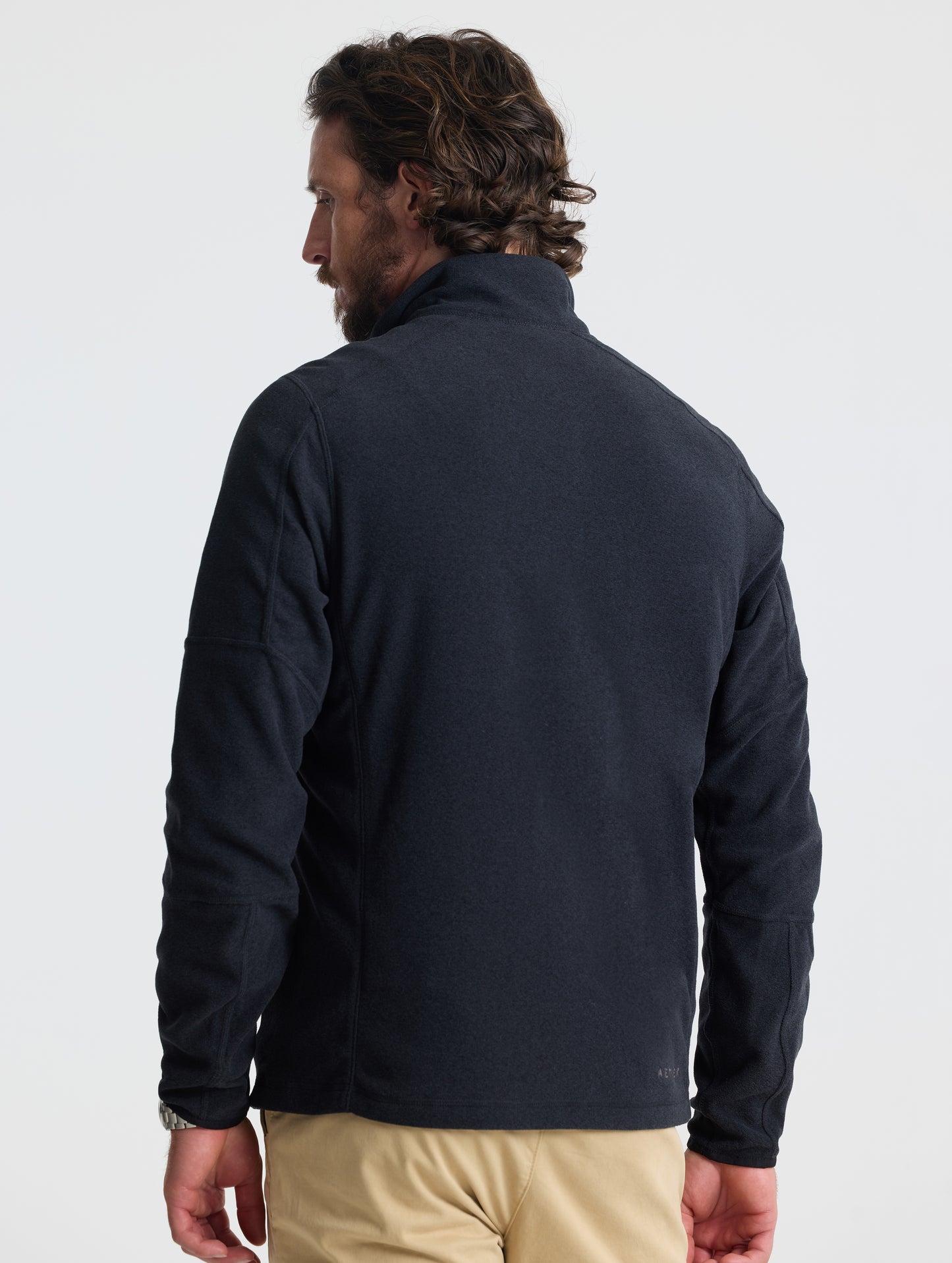 Rear view of man wearing Sutherlin Full-Zip in Onyx Black from AETHER Apparel.