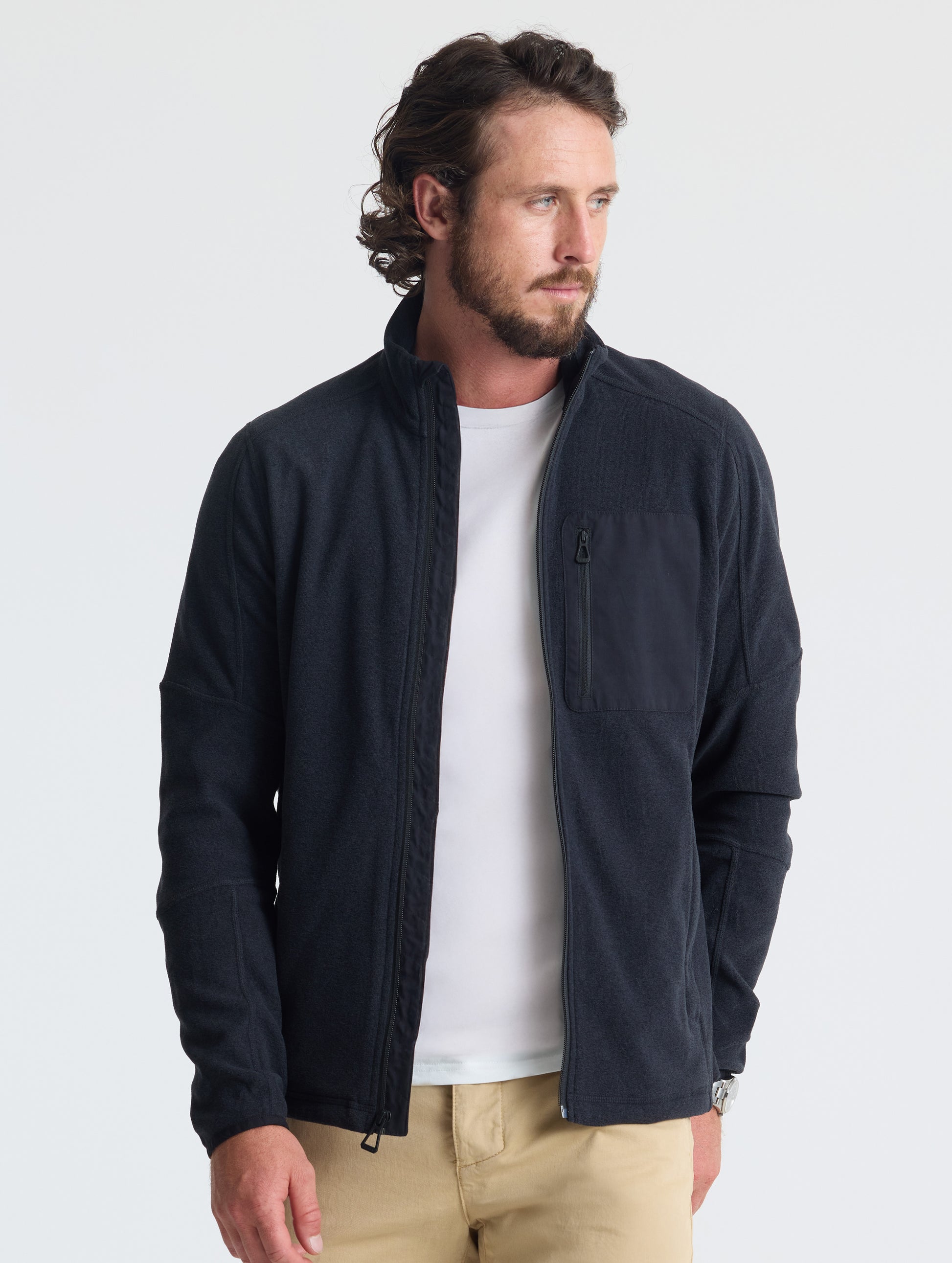 Front view of man wearing unzipped Sutherlin Full-Zip in Onyx Black from AETHER Apparel.
