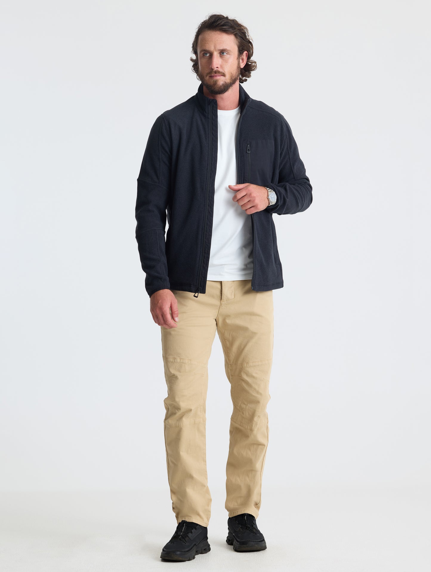 Full body view of man wearing Sutherlin Full-Zip in Onyx Black from AETHER Apparel.