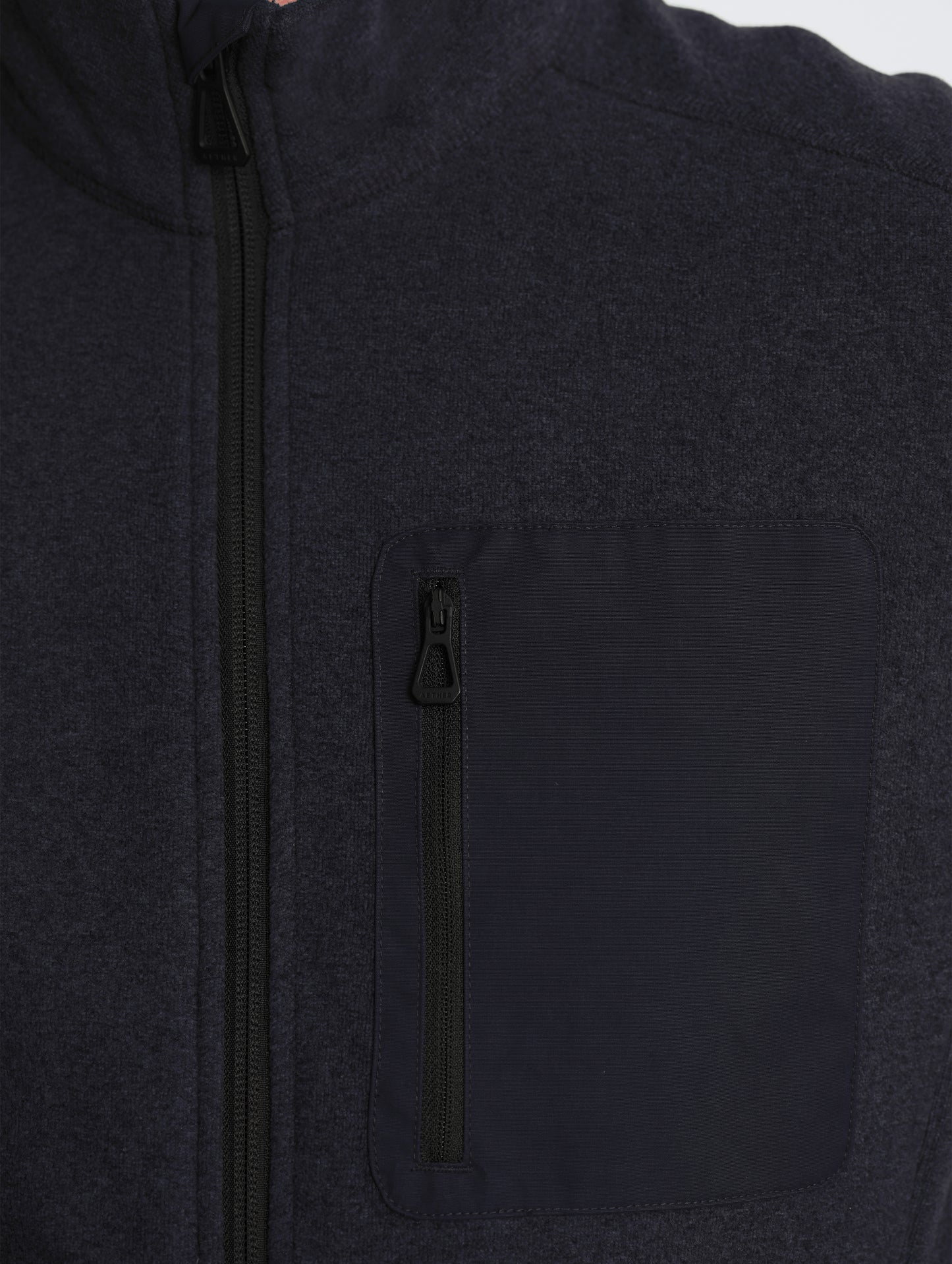 Closeup view of front zipper of Sutherlin Full-Zip in Onyx Black from AETHER Apparel.