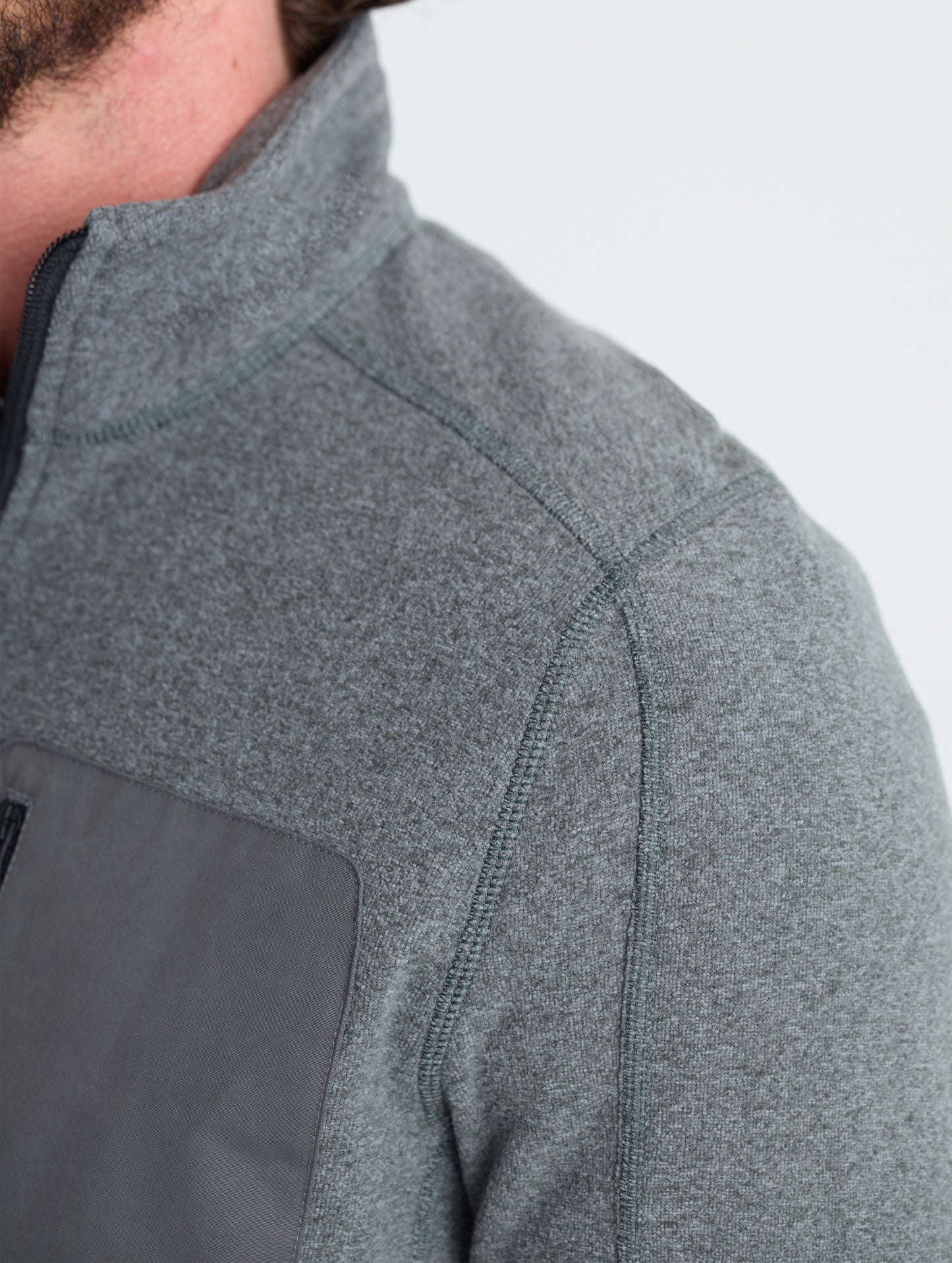 Closeup detail view of wearer's left shoulder of Sutherlin Half-Zip in Charcoal Heather from AETHER Apparel.