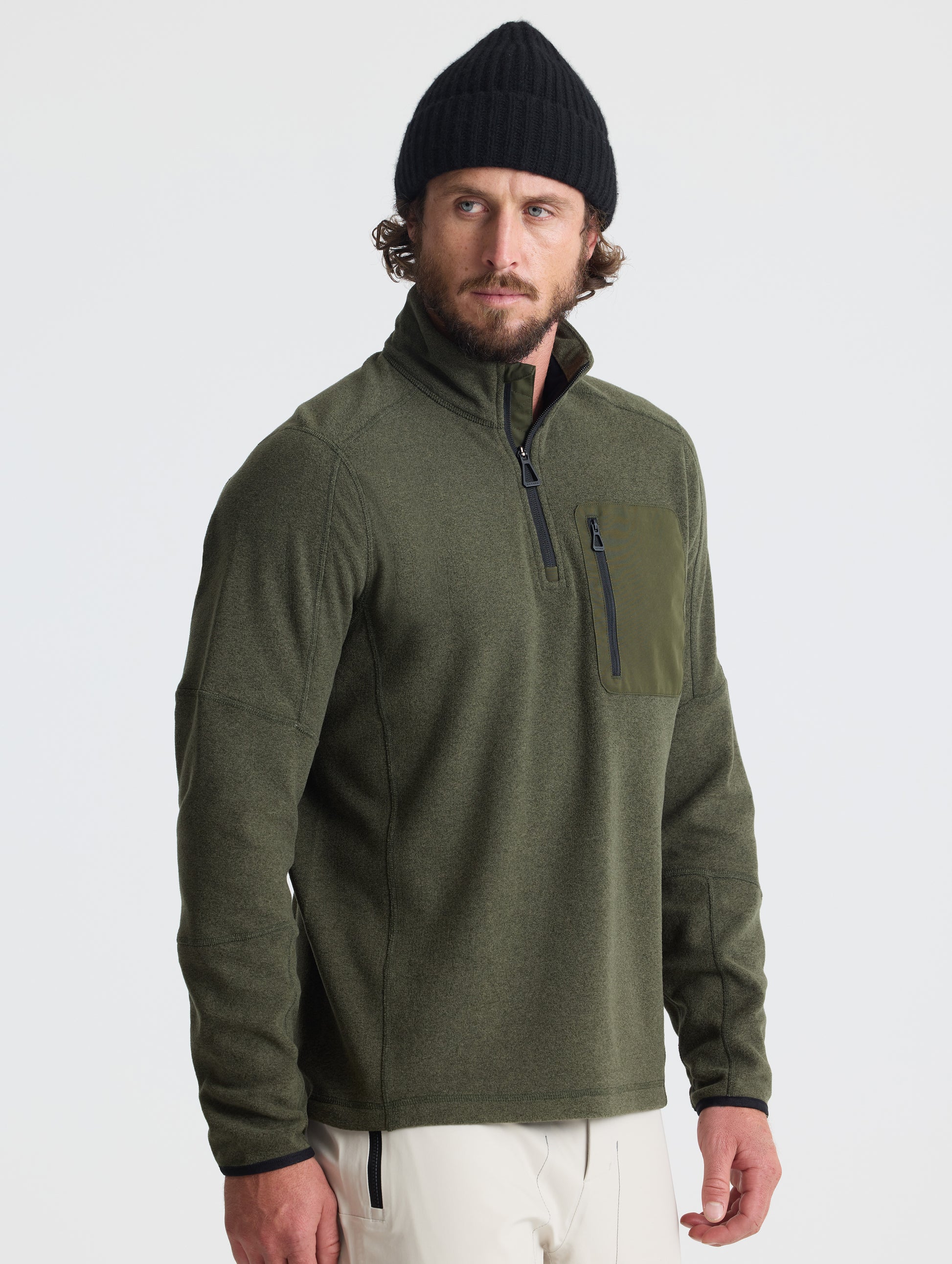 Angled view of man wearing Sutherlin Half-Zip in Forest Green from AETHER Apparel.