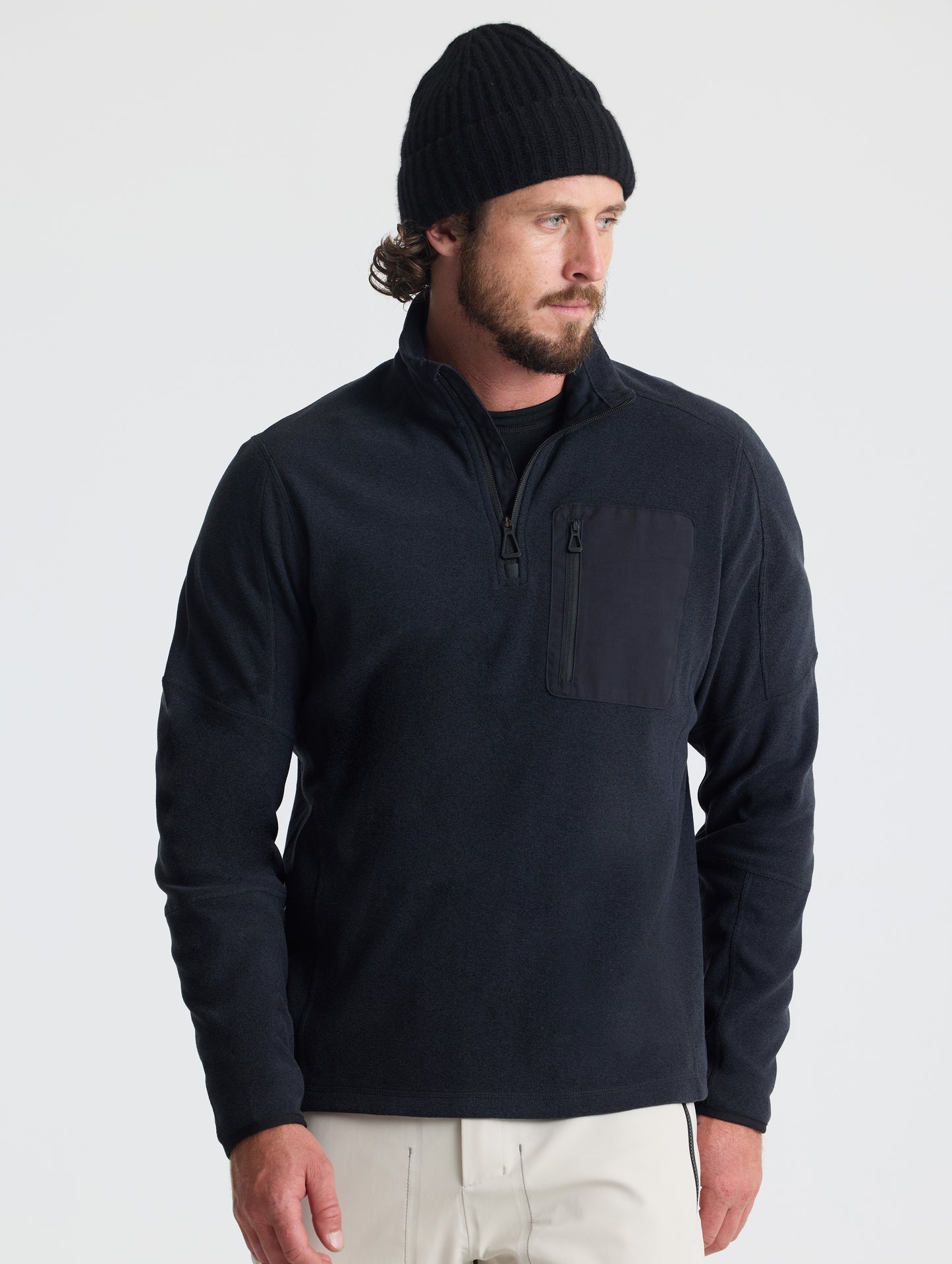 Front view of man wearing Sutherlin Half-Zip in Onyx Black from AETHER Apparel.