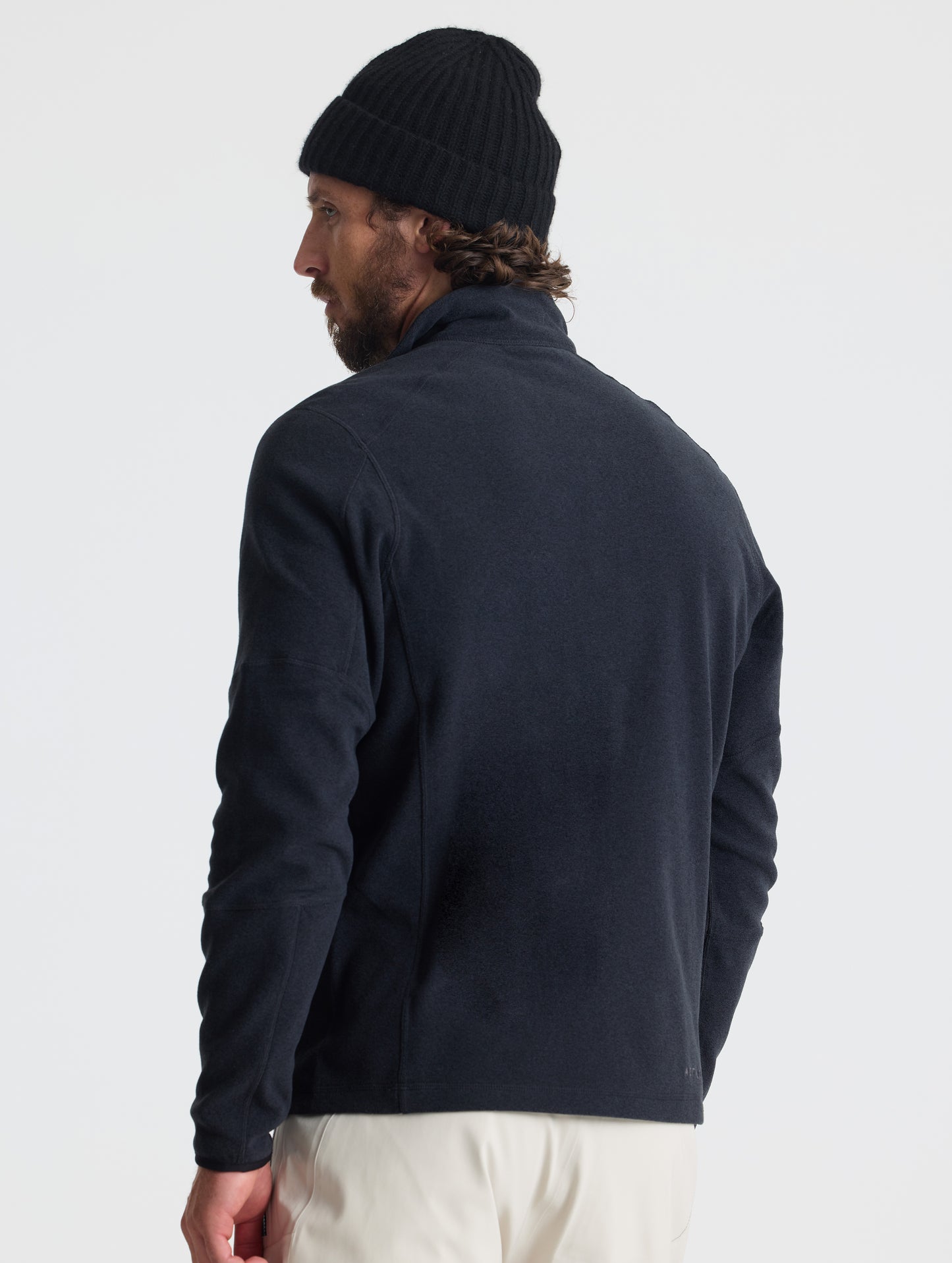 Rear view of man wearing Sutherlin Half-Zip in Onyx Black from AETHER Apparel.