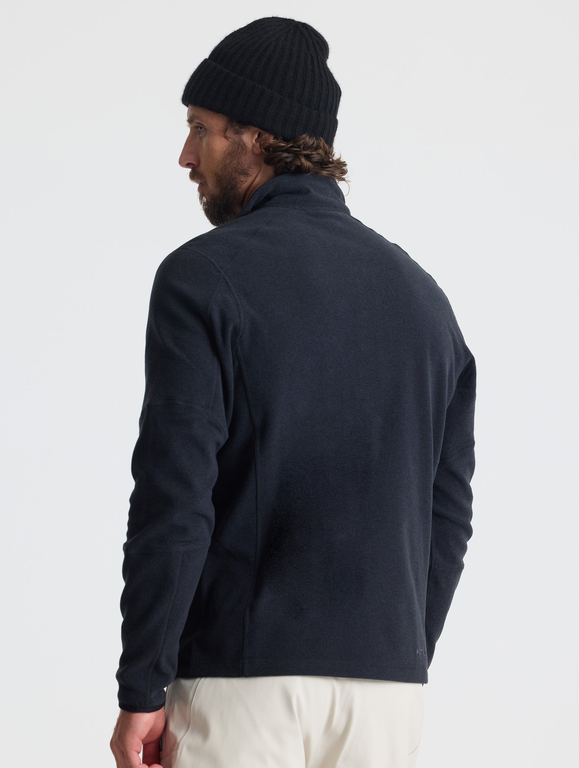 Rear view of man wearing Sutherlin Half-Zip in Onyx Black from AETHER Apparel.