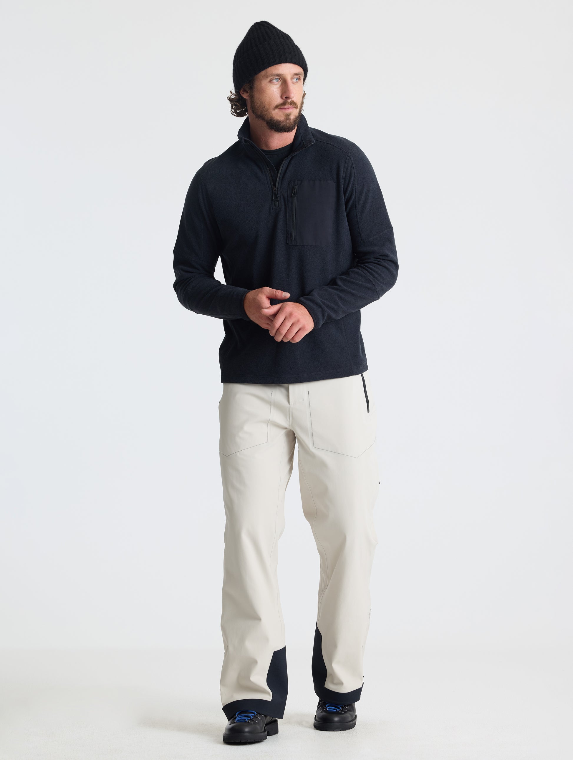 Full body view of man wearing Sutherlin Half-Zip in Onyx Black from AETHER Apparel.