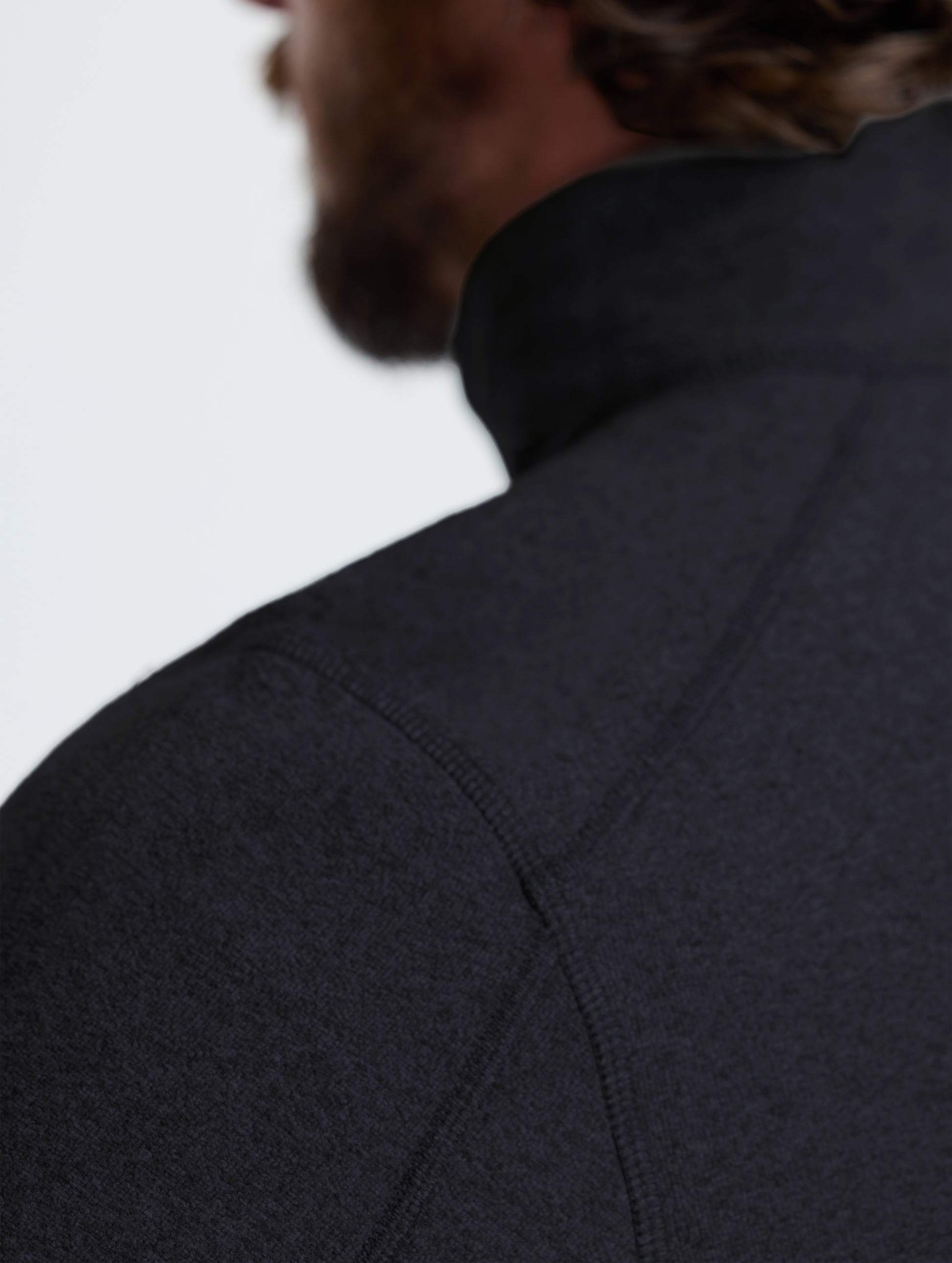 Closeup rear view of left shoulder detail of Sutherlin Half-Zip in Onyx Black from AETHER Apparel.