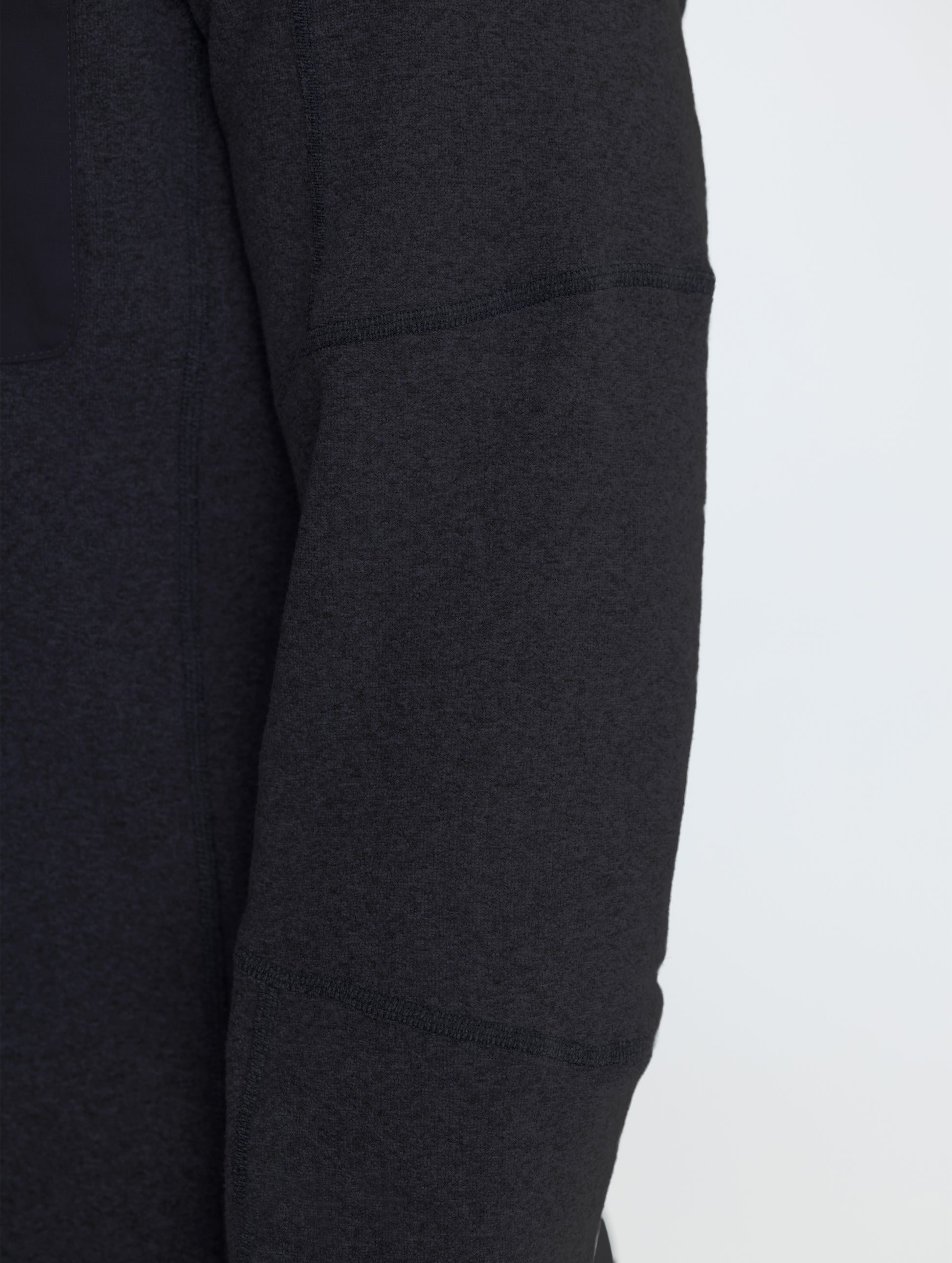 Closeup rear view of right sleeve of Sutherlin Half-Zip in Onyx Black from AETHER Apparel.