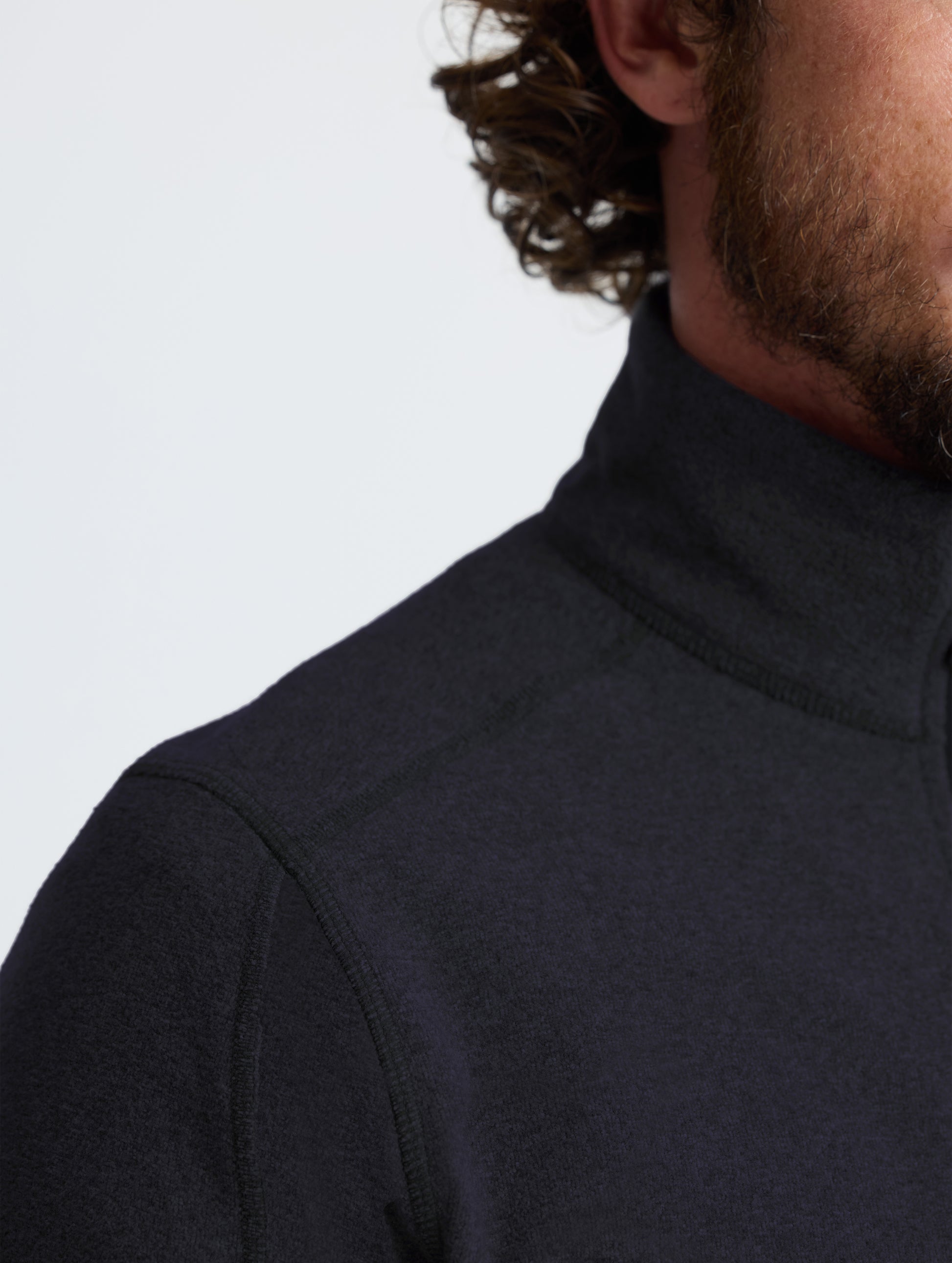 Closeup view of right shoulder detail of Sutherlin Half-Zip in Onyx Black from AETHER Apparel.